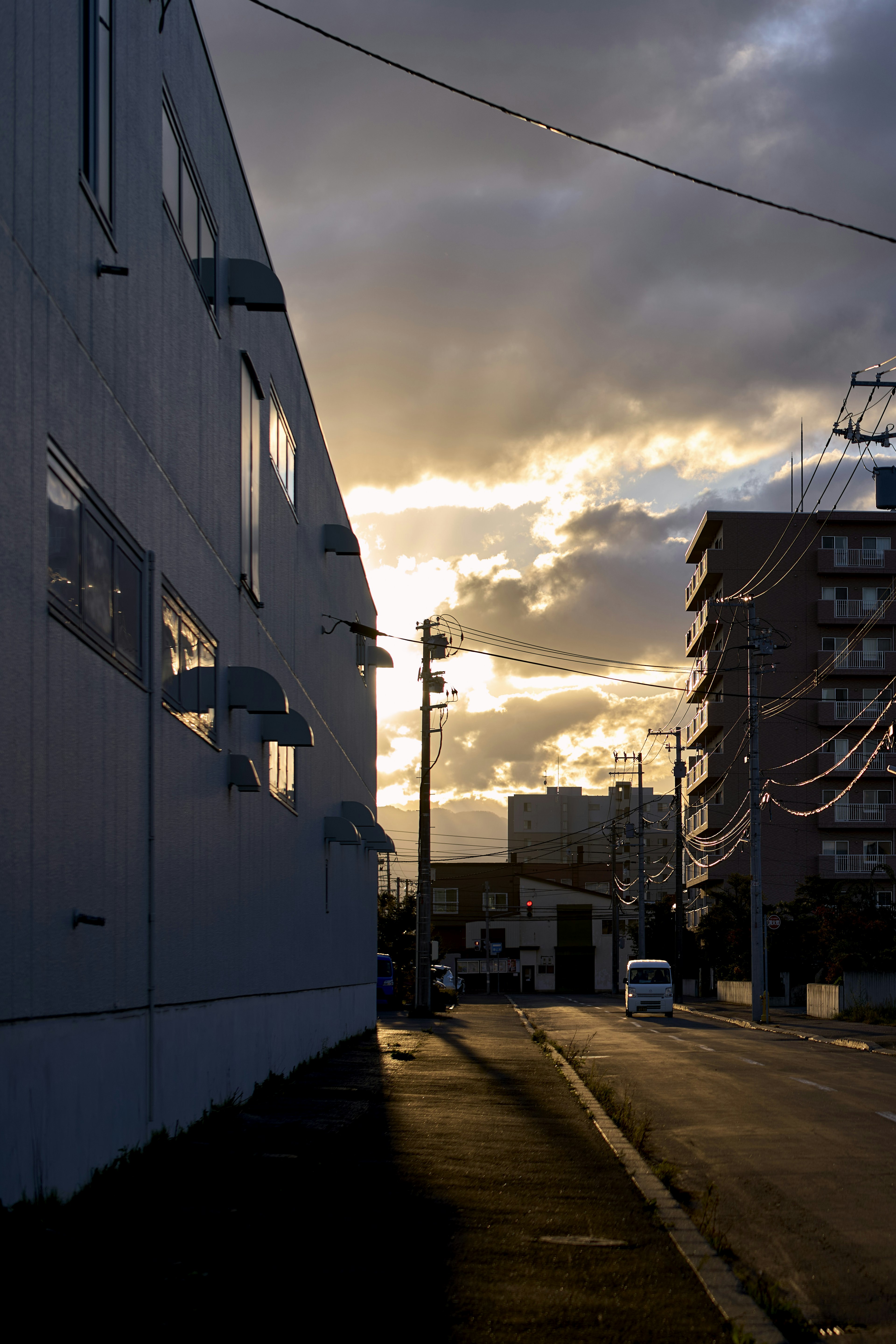 Urban street scene at sunset with dramatic clouds