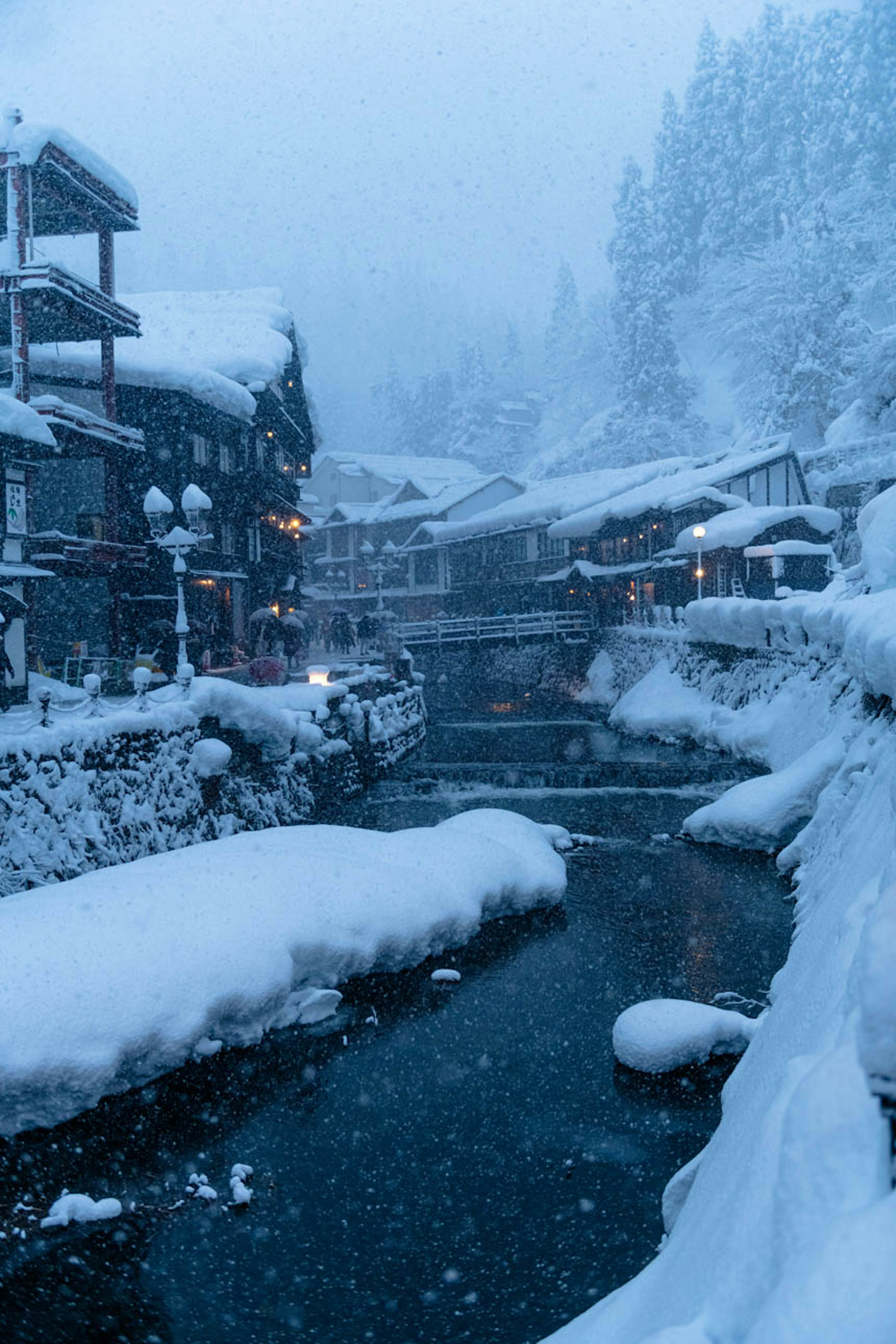 Snow-covered village with a serene river scene