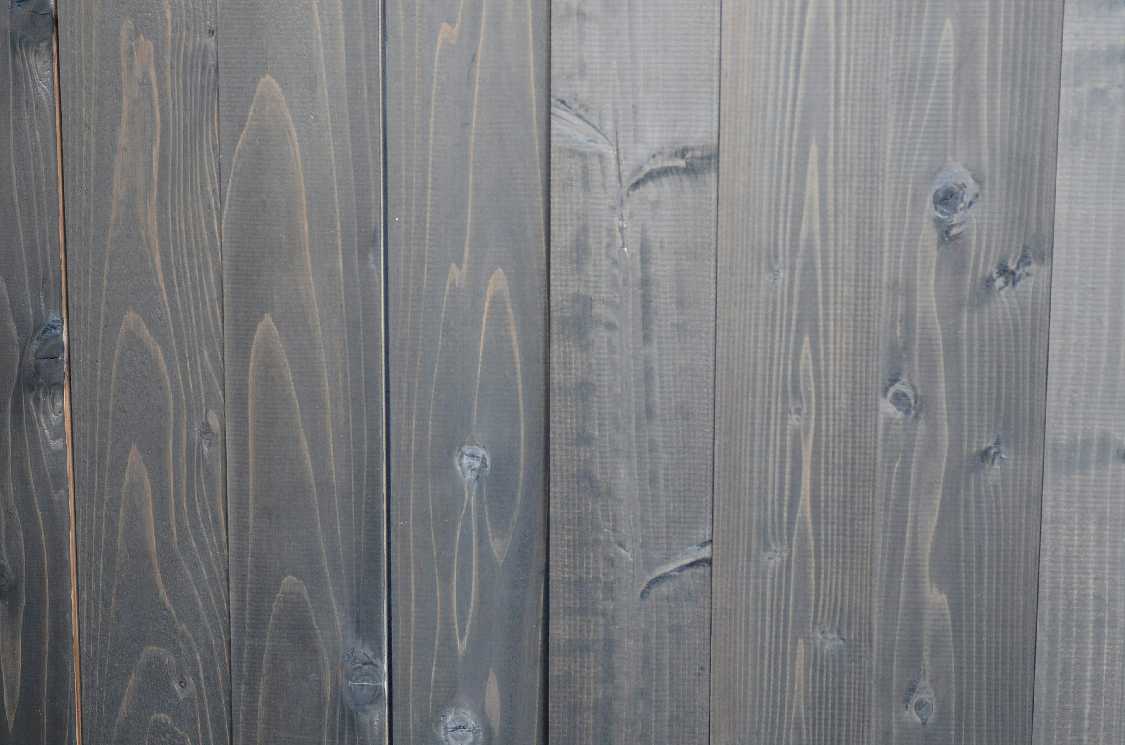 Gray wooden wall featuring distinctive texture