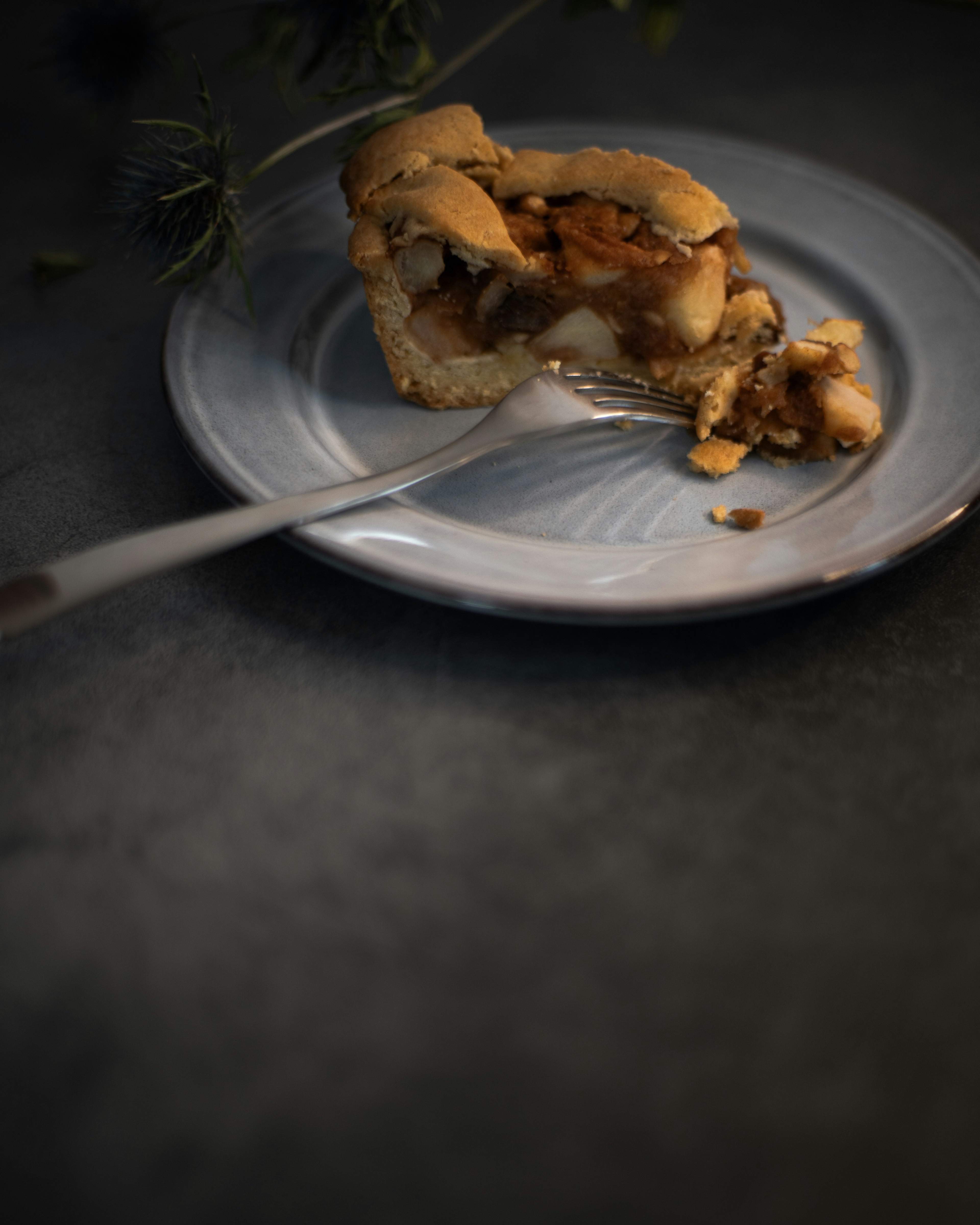 A piece of baked dessert on a plate with a fork