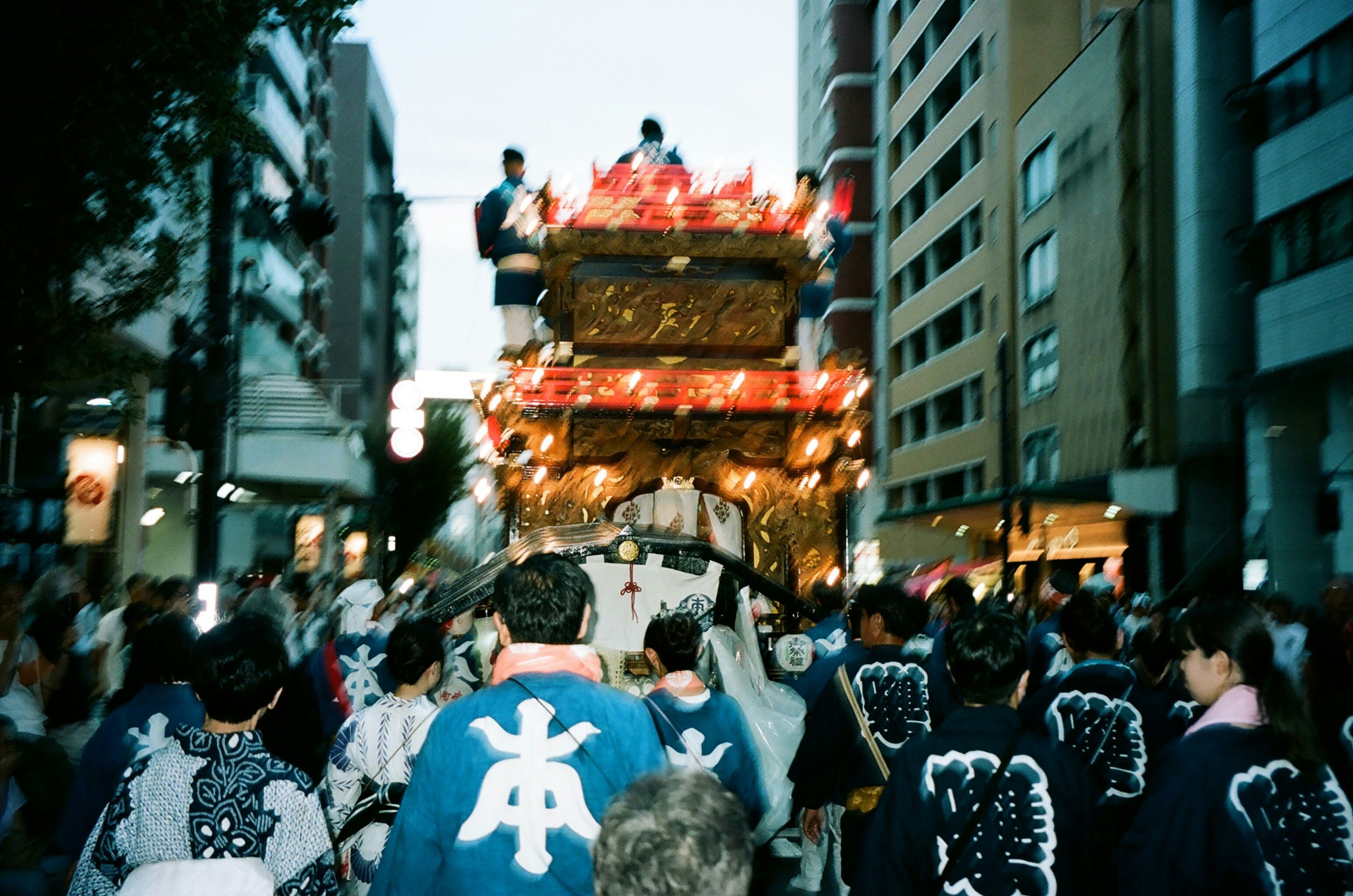 Vibrant festival scene with a decorated float moving through the streets