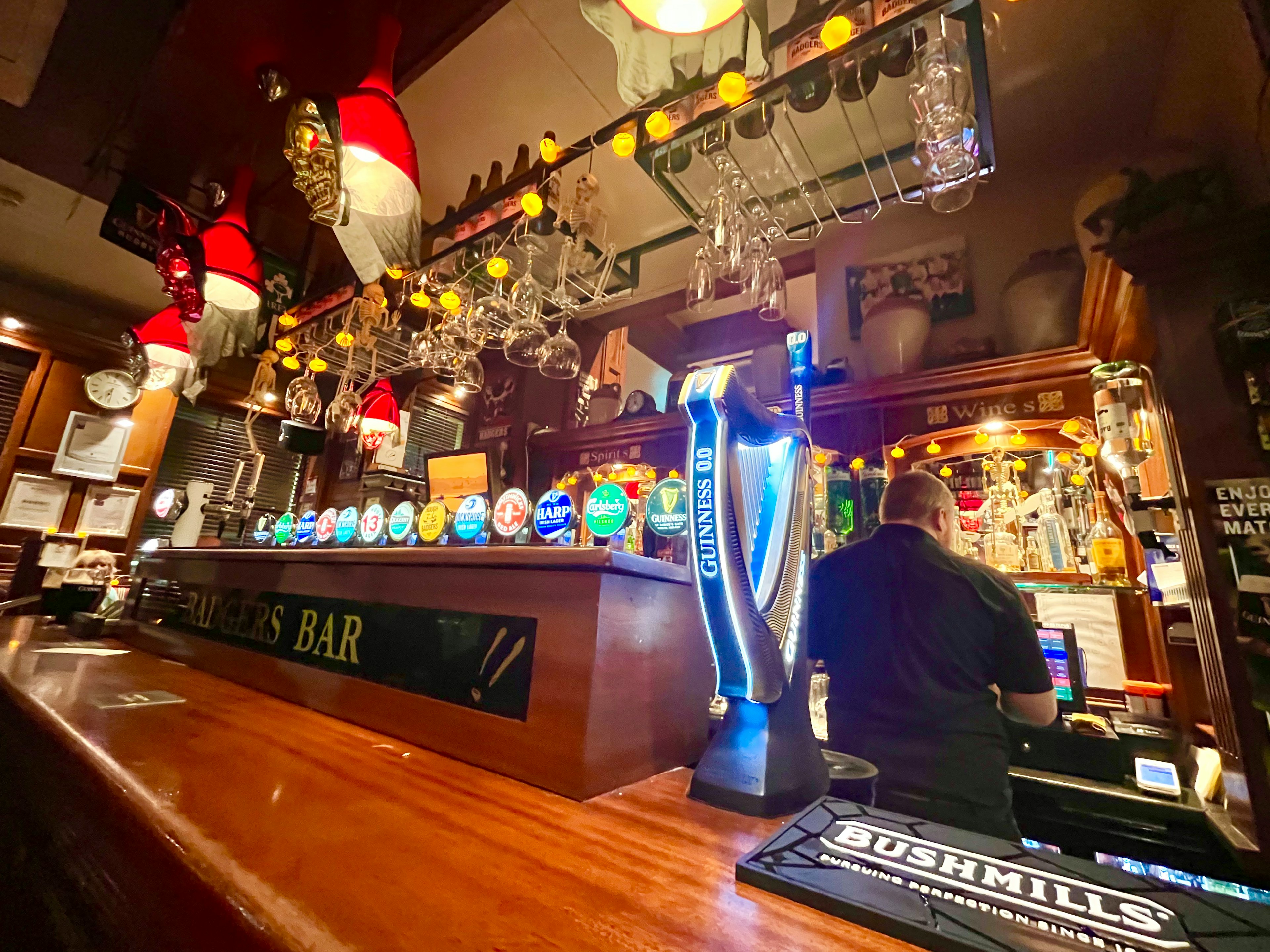 Interior of a lively bar with a counter and beer taps