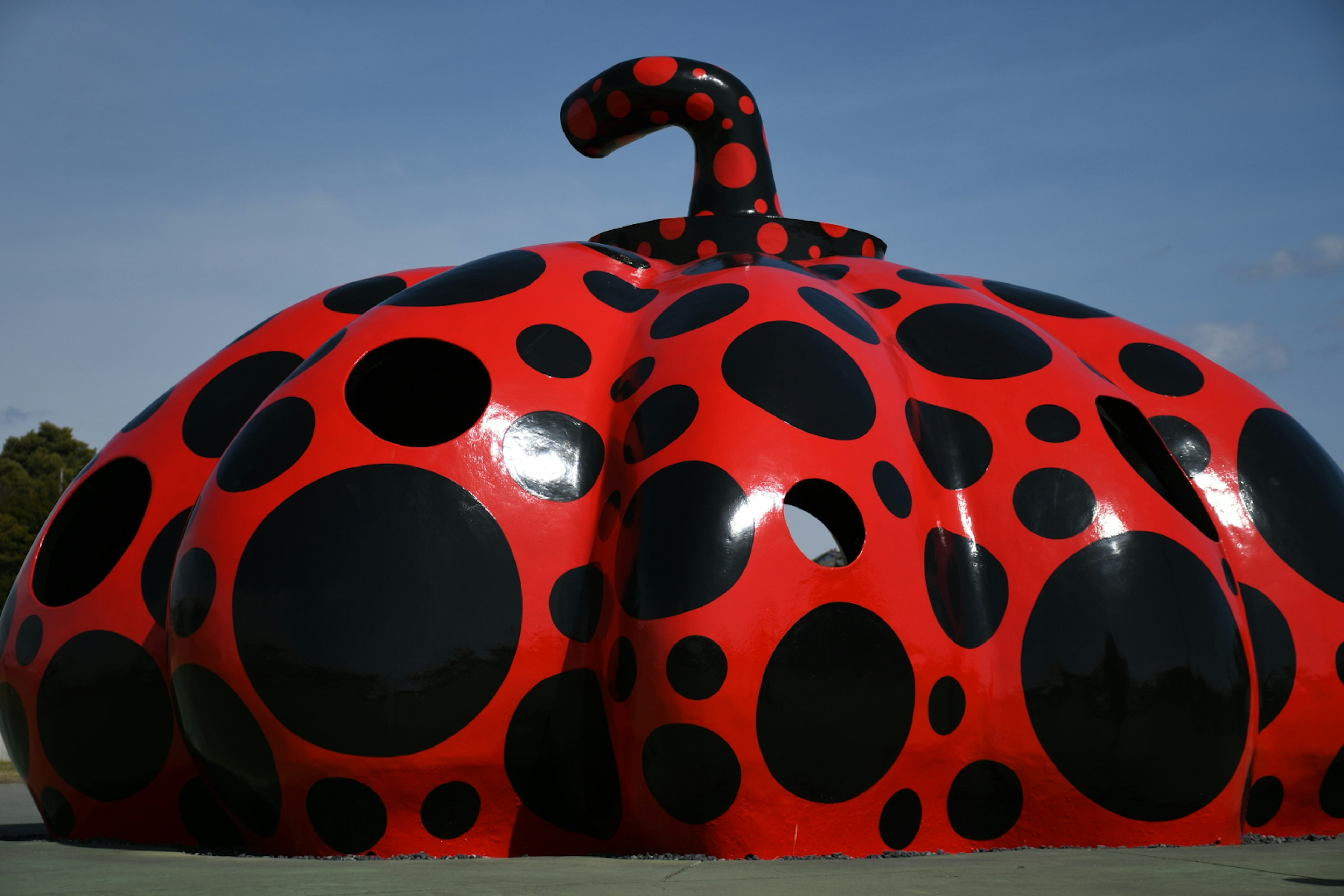 Red and black polka dot pumpkin sculpture