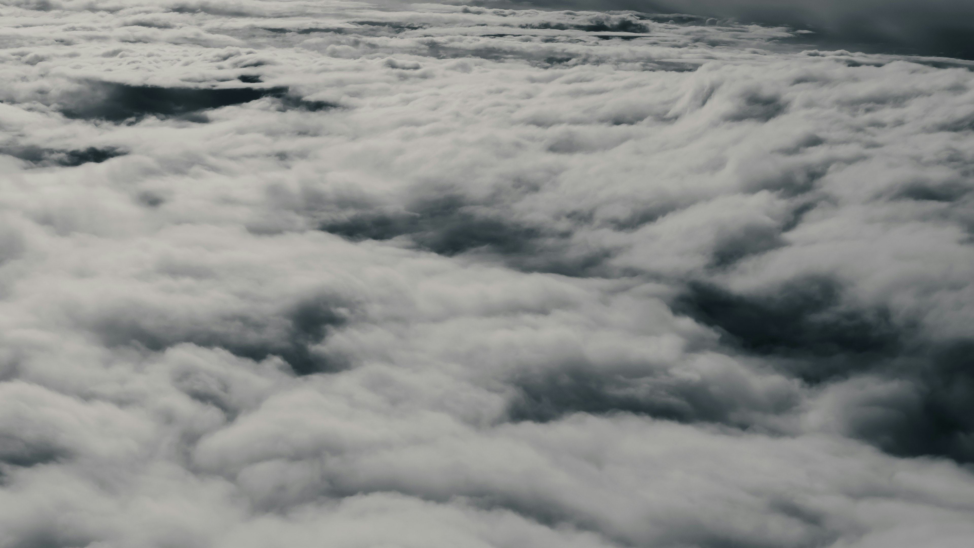 Aerial view of dense clouds with varying shades of gray