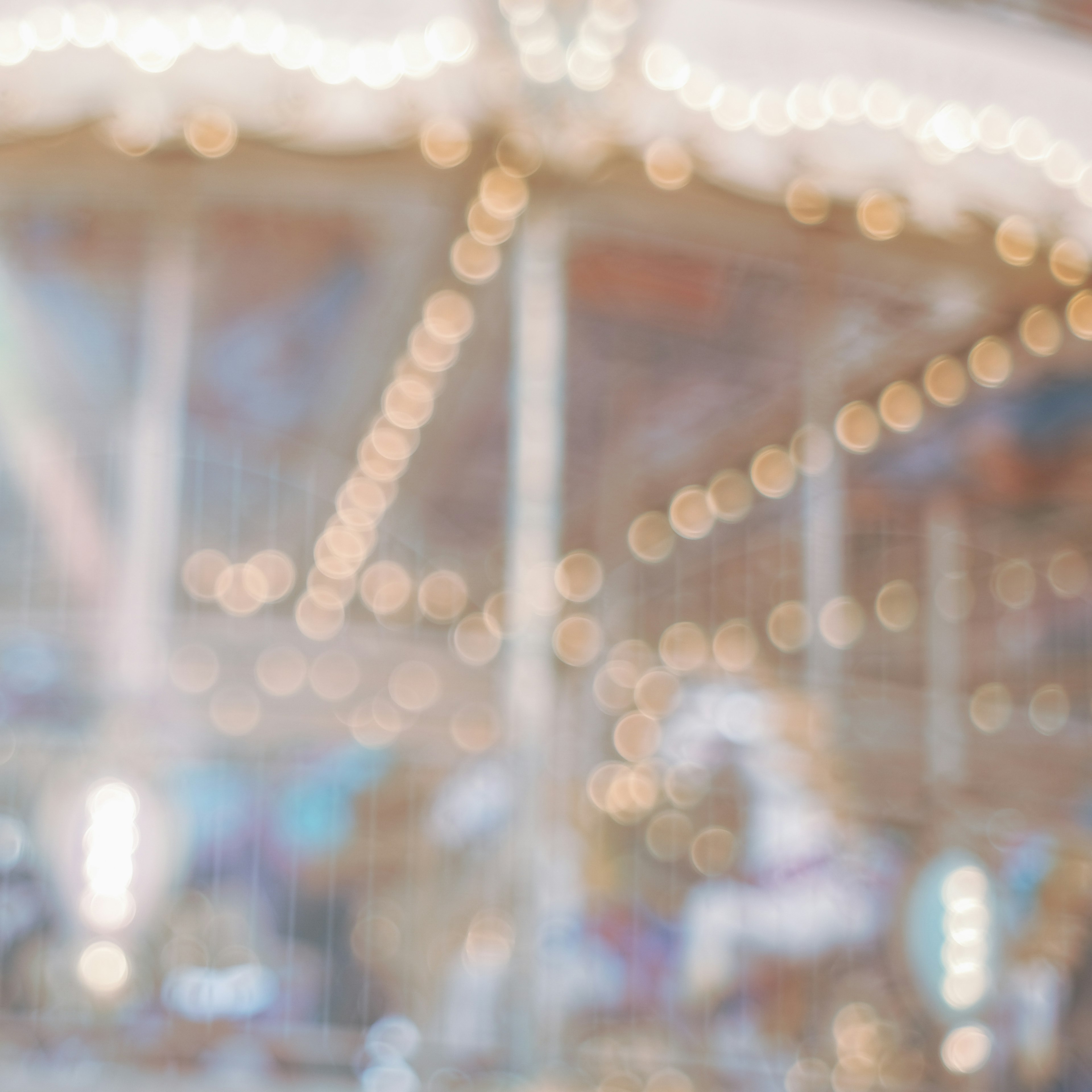 Blurred background of a carousel with bright lights sparkling