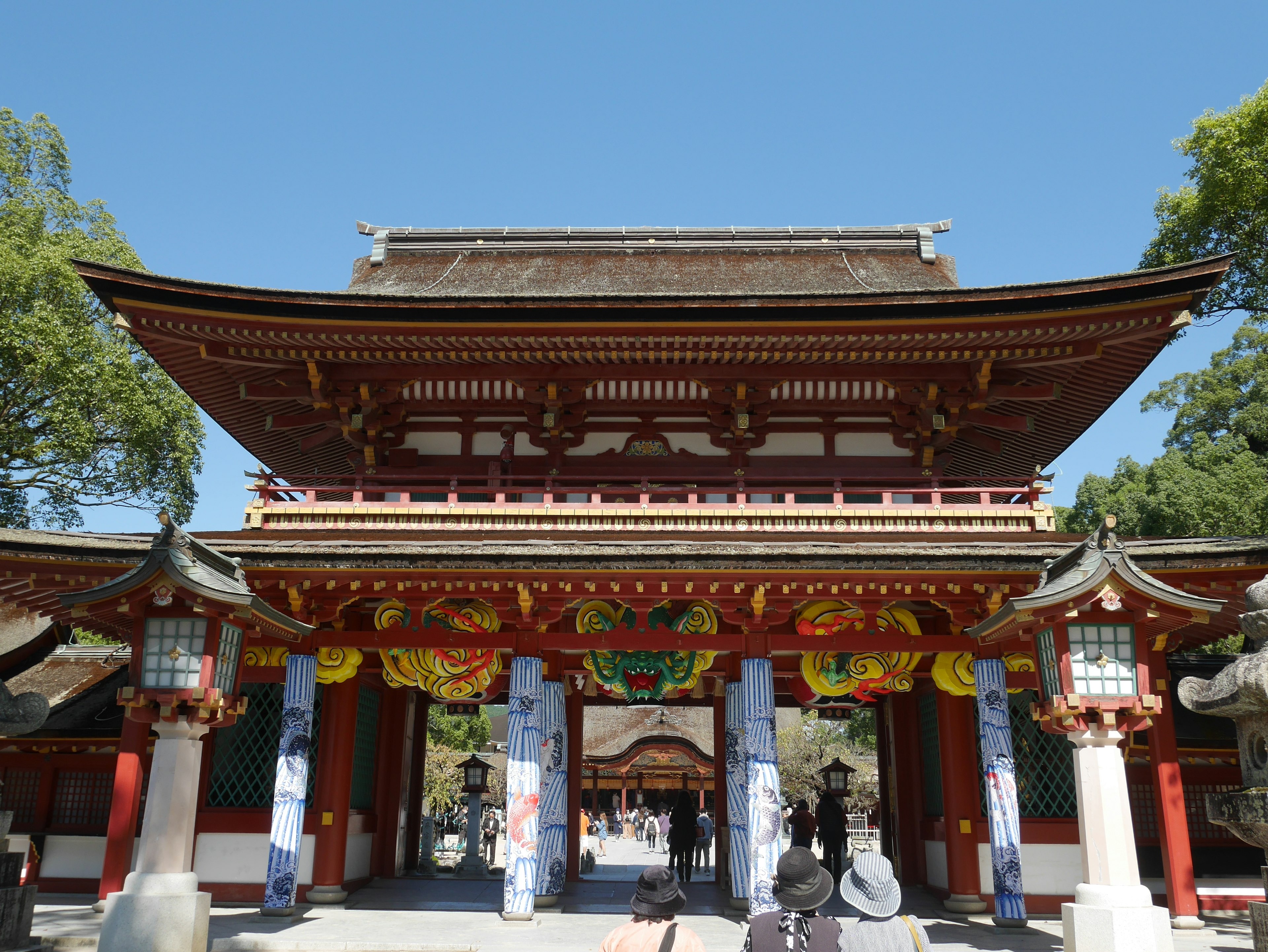 Entrance of a beautiful Japanese shrine with vibrant decorations on the structure