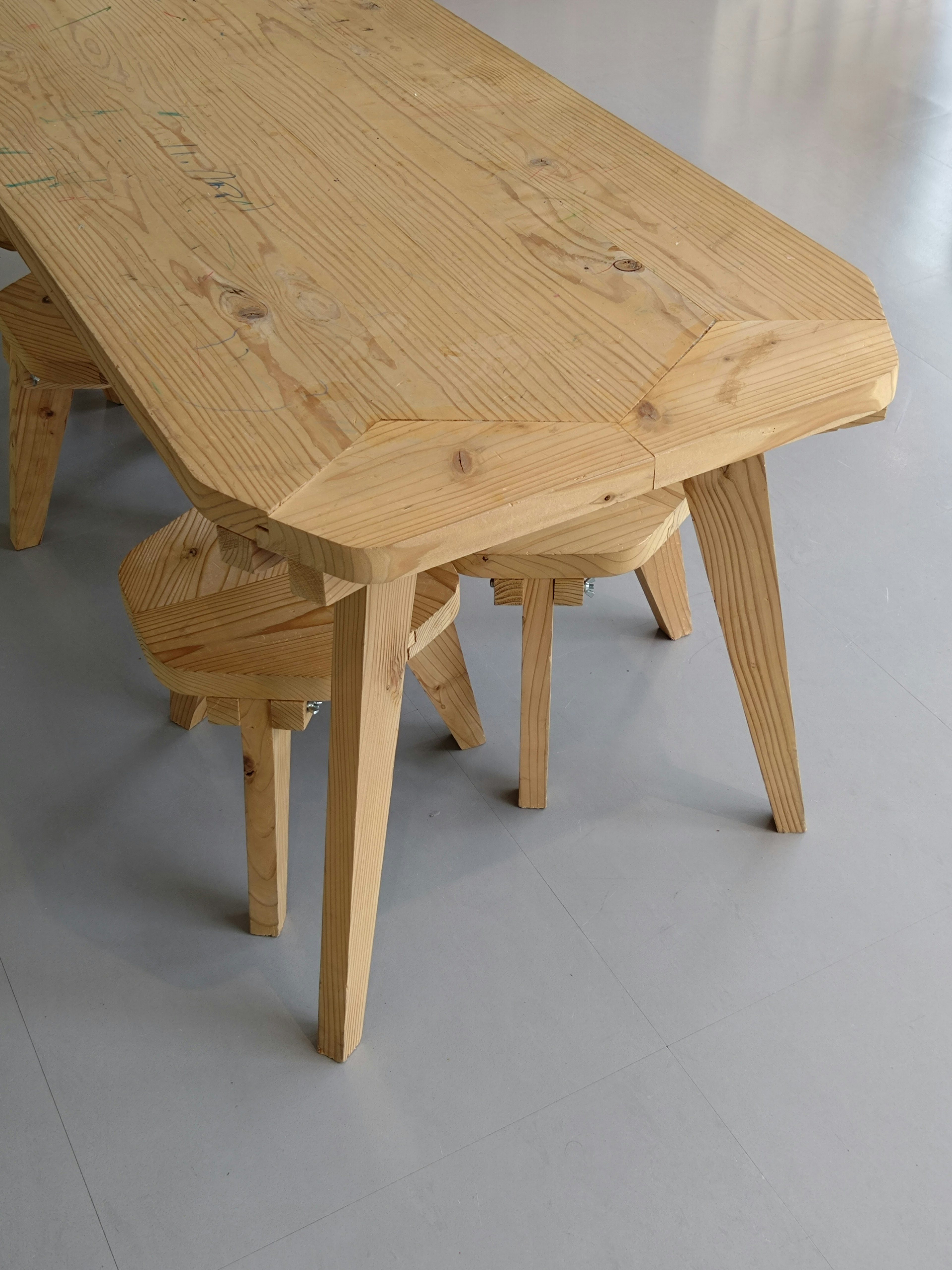 Wooden table and chair set featuring a simple design and natural wood texture