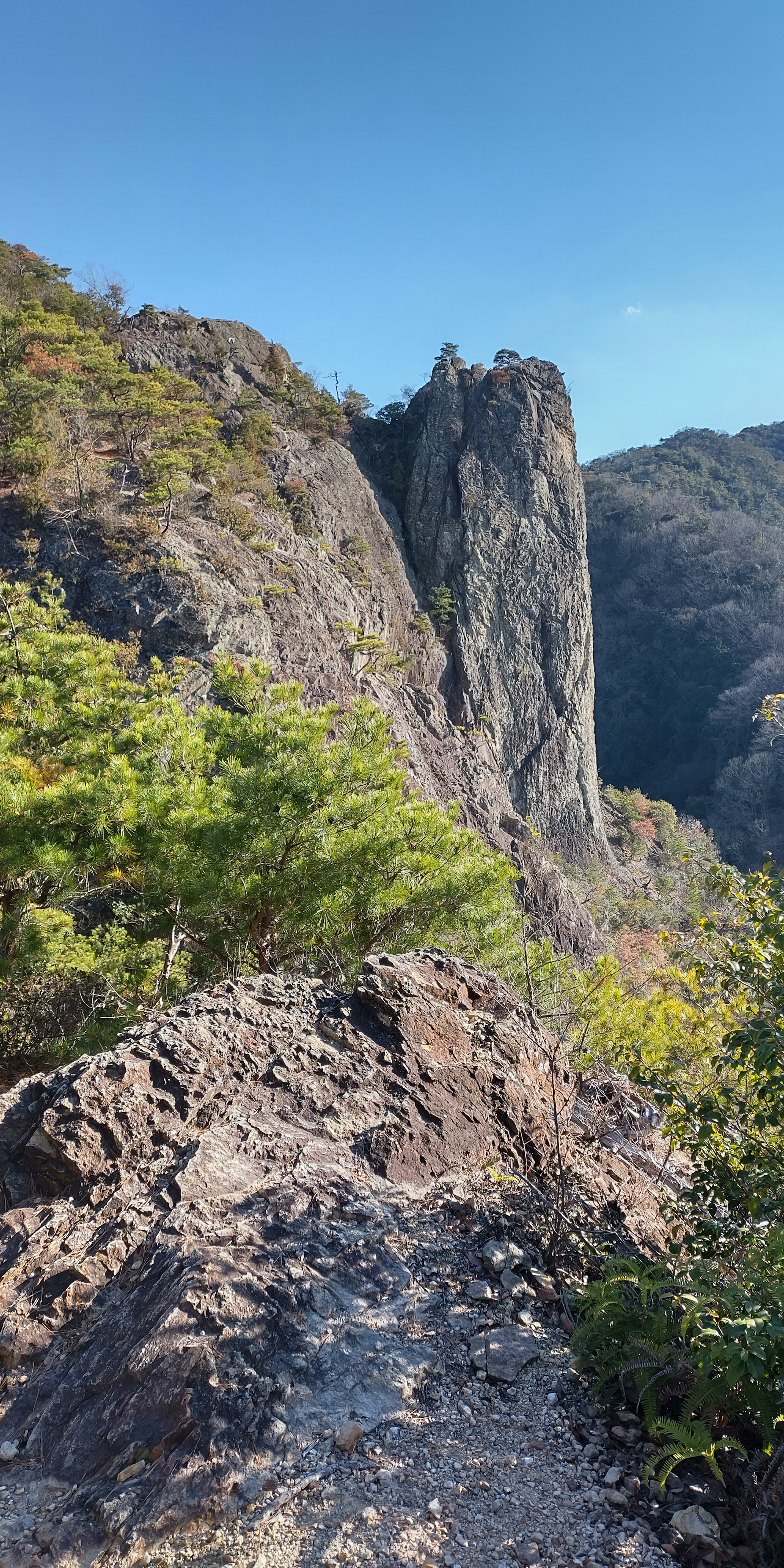 Trail along rocky terrain with towering rock formation