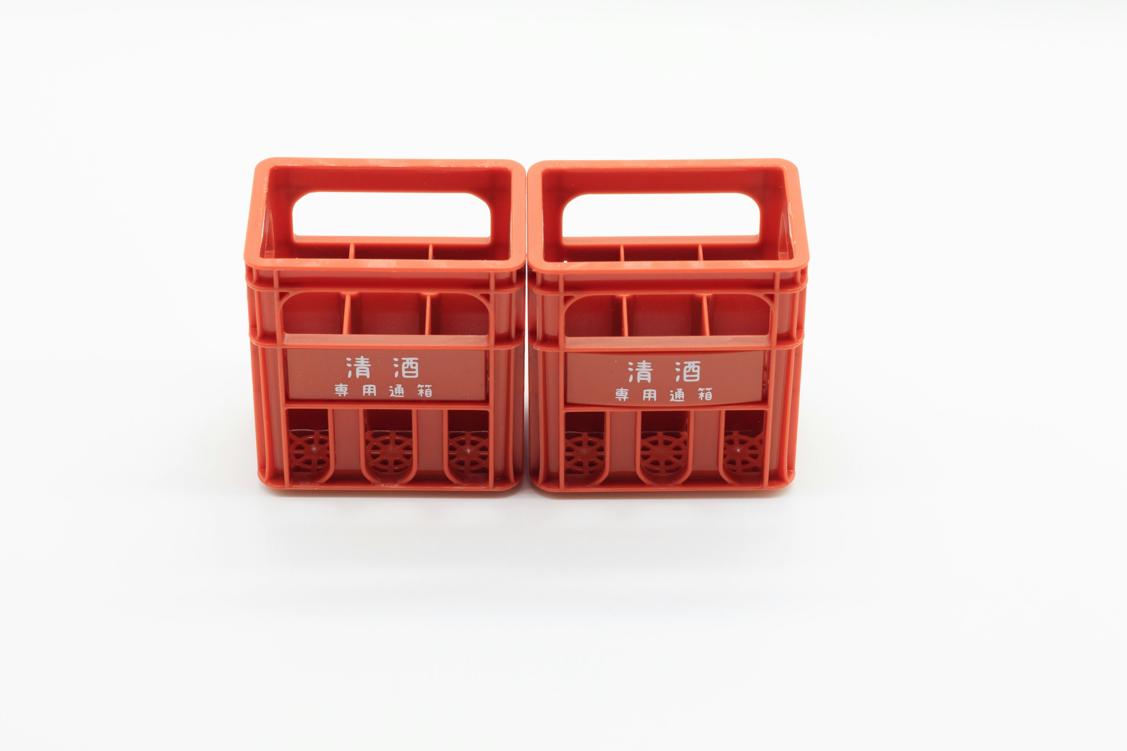 Two red plastic storage crates are placed side by side