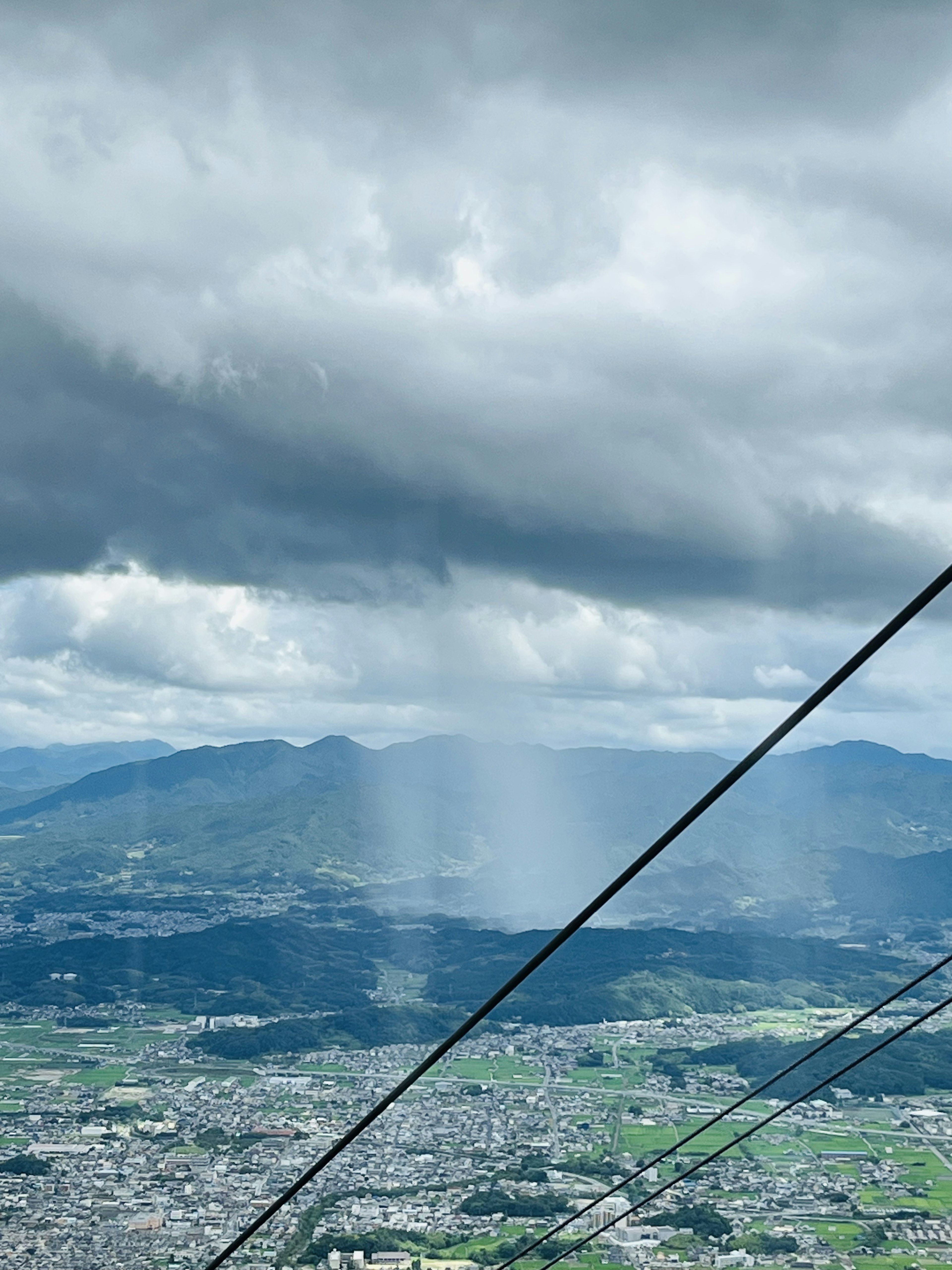 Mountain and cloud scenery with cable car wires