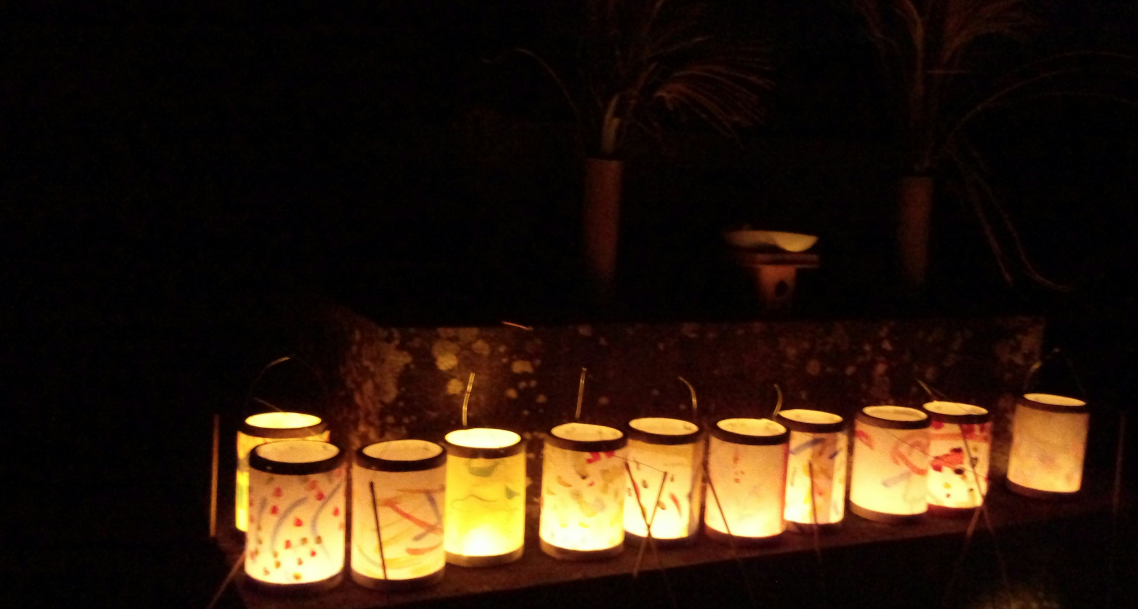 Handmade lanterns emitting soft light against a dark background