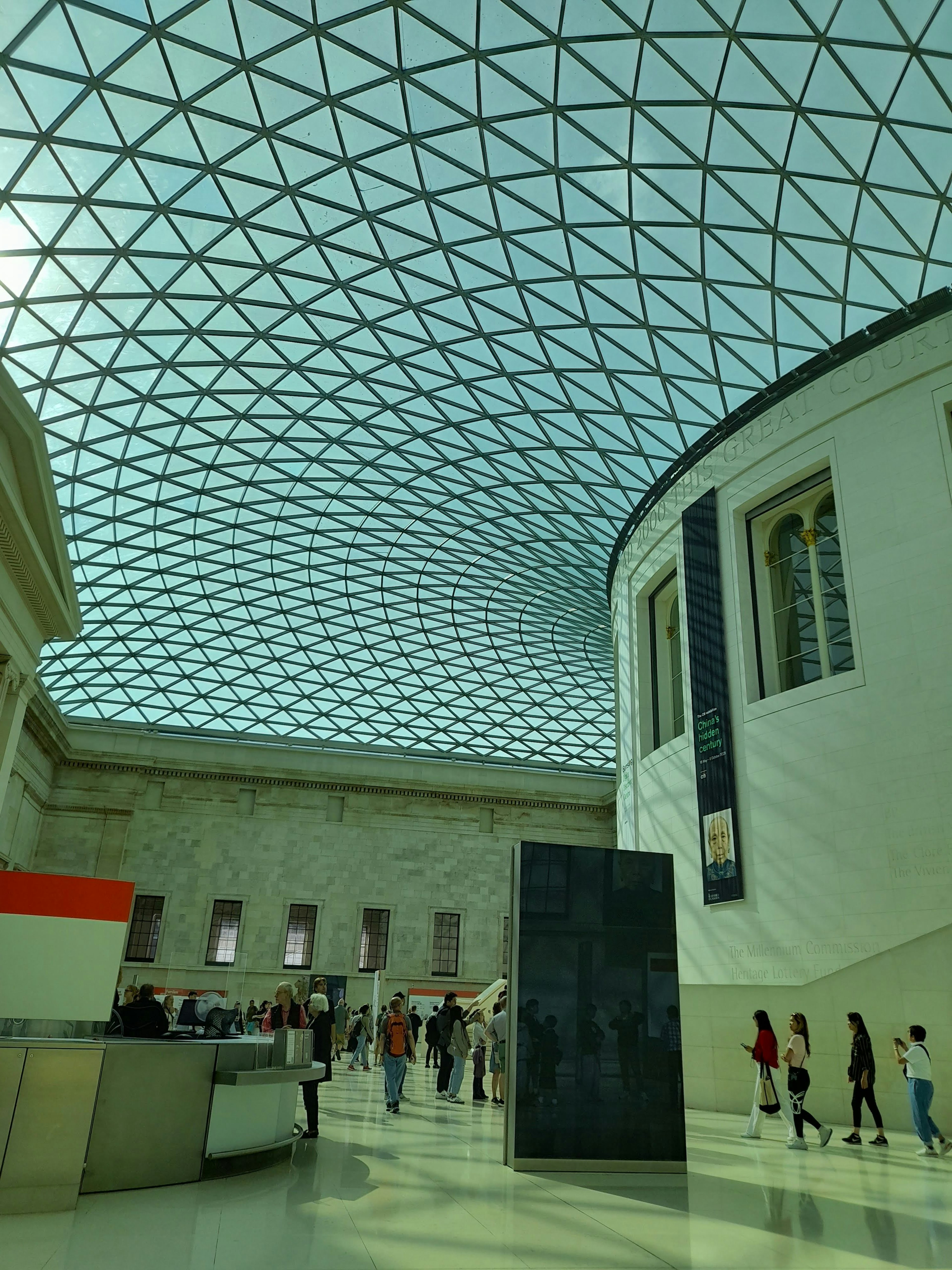 Interior view of the British Museum featuring a glass ceiling and curved walls