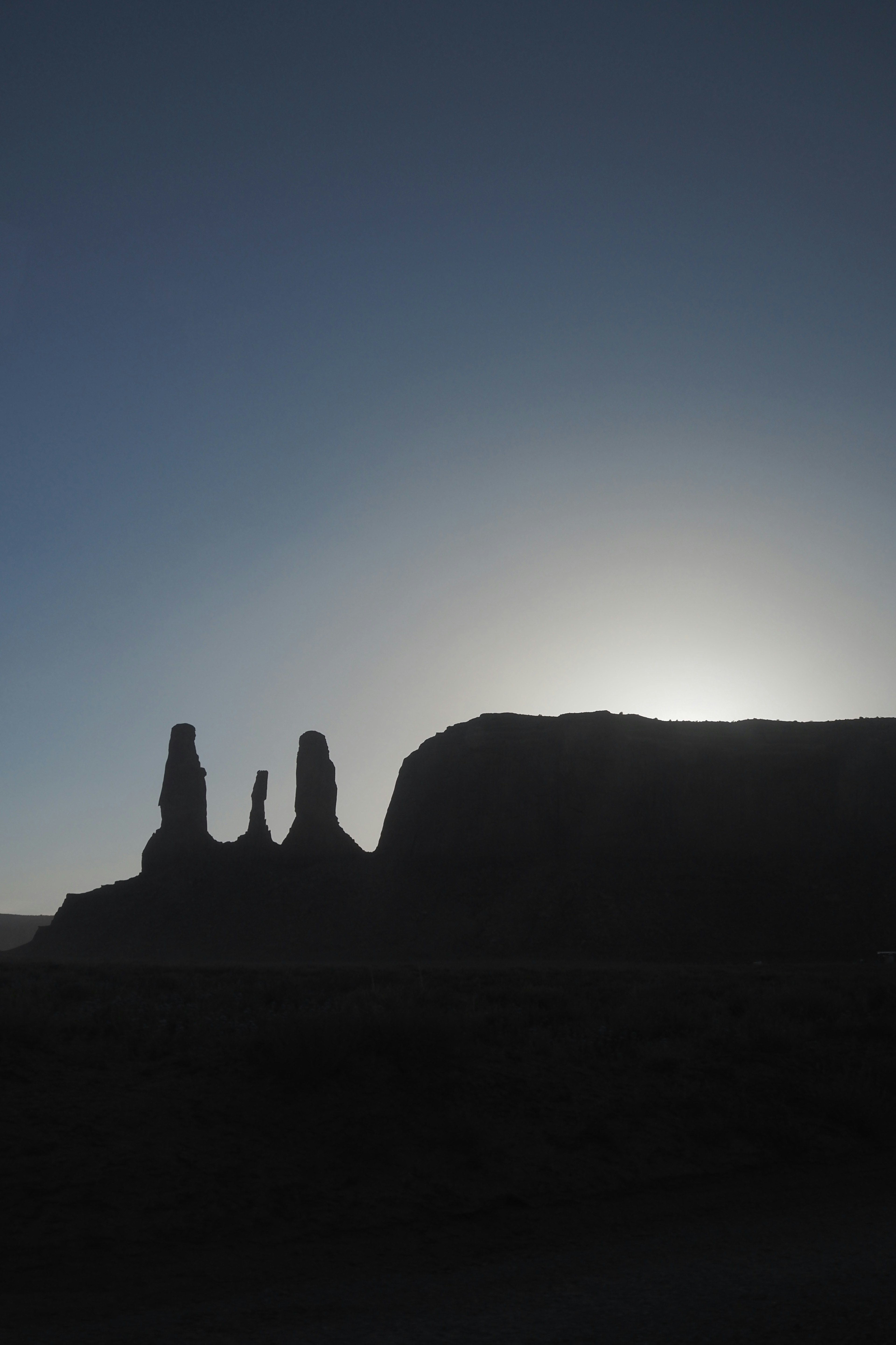 Silhouette of Monument Valley rock formations against the sunset