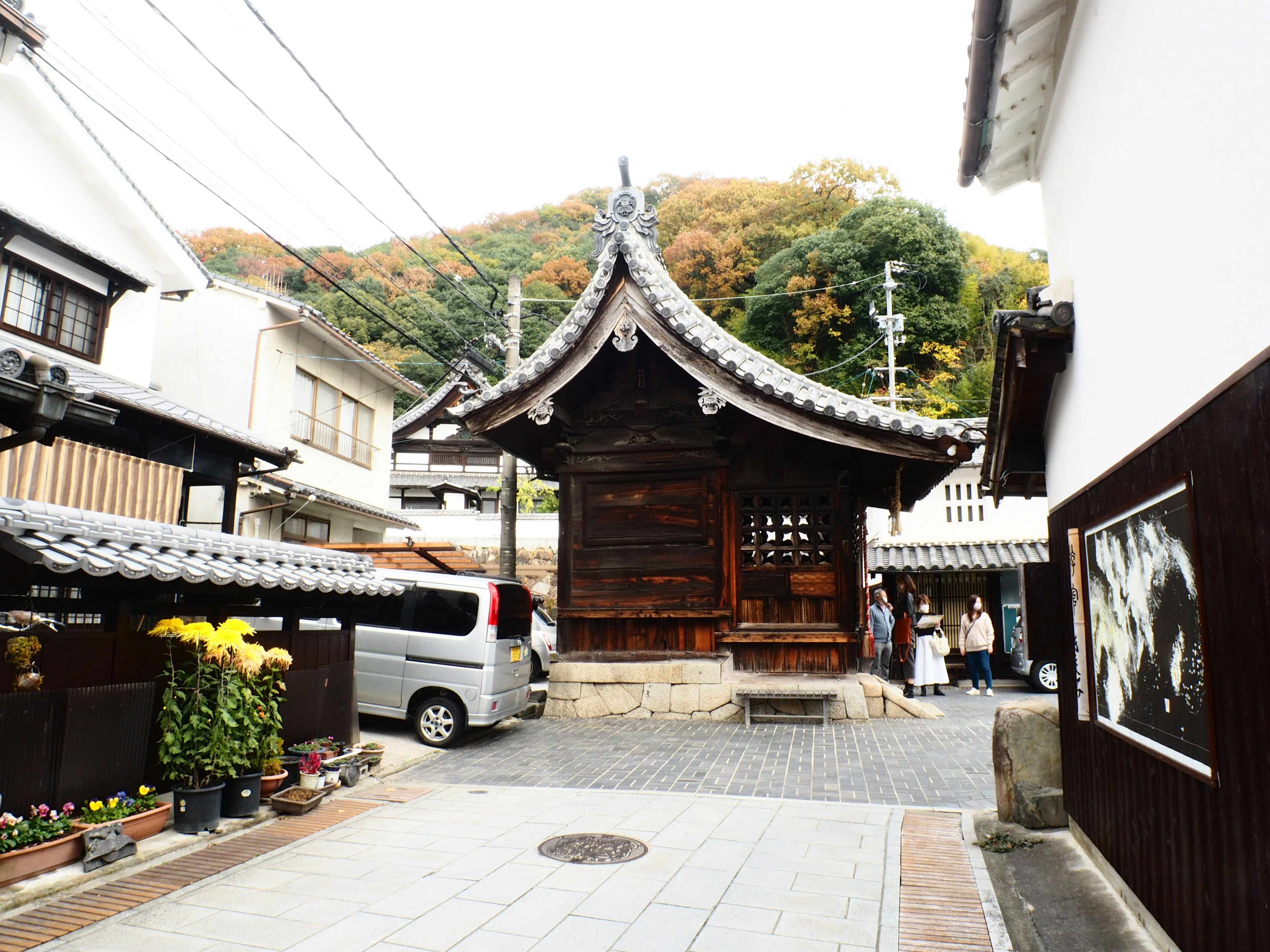 A quiet street corner featuring an old wooden building