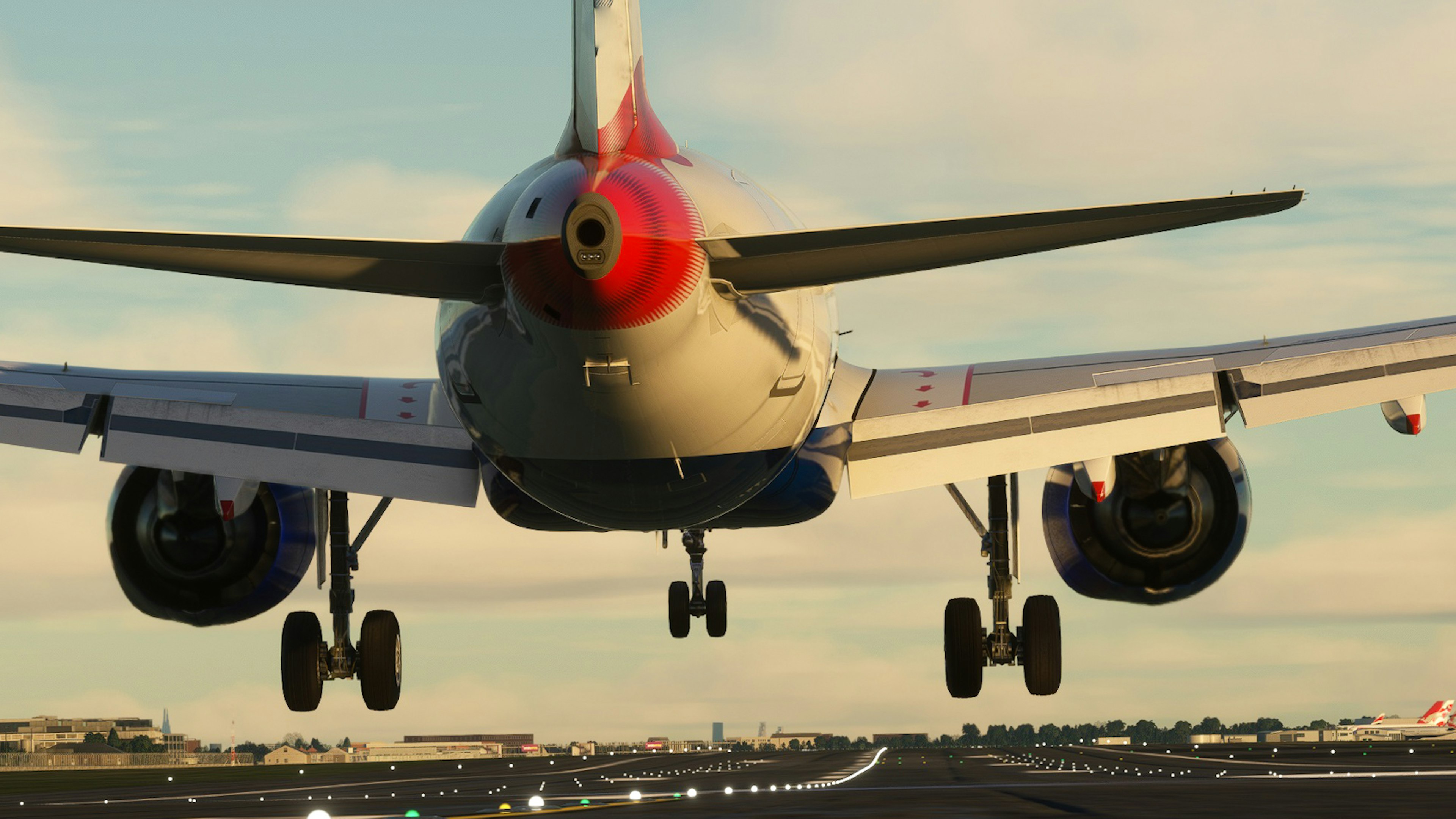 Avión aterrizando en una pista de aeropuerto visto desde atrás