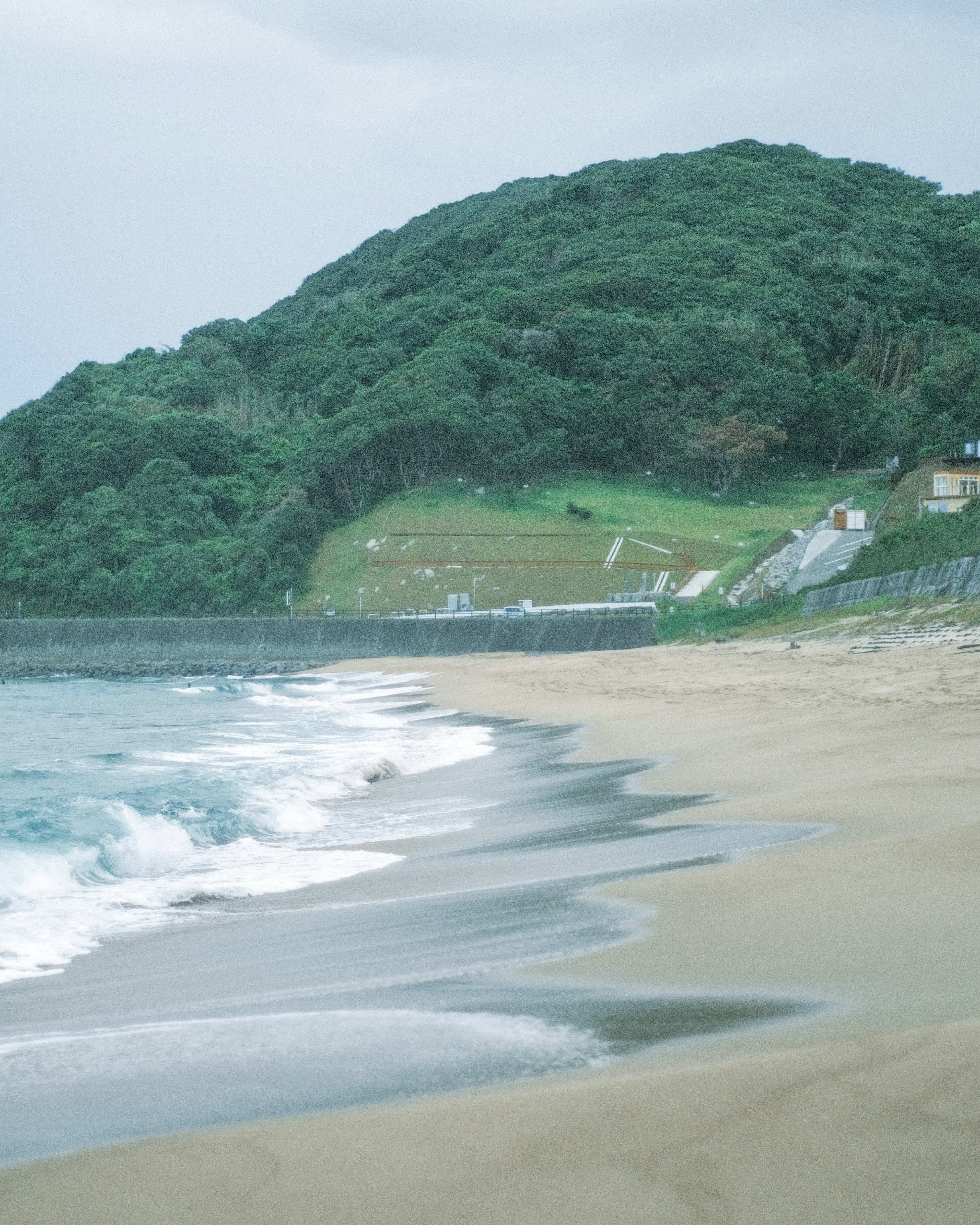 Beach view with coastline and lush green hill