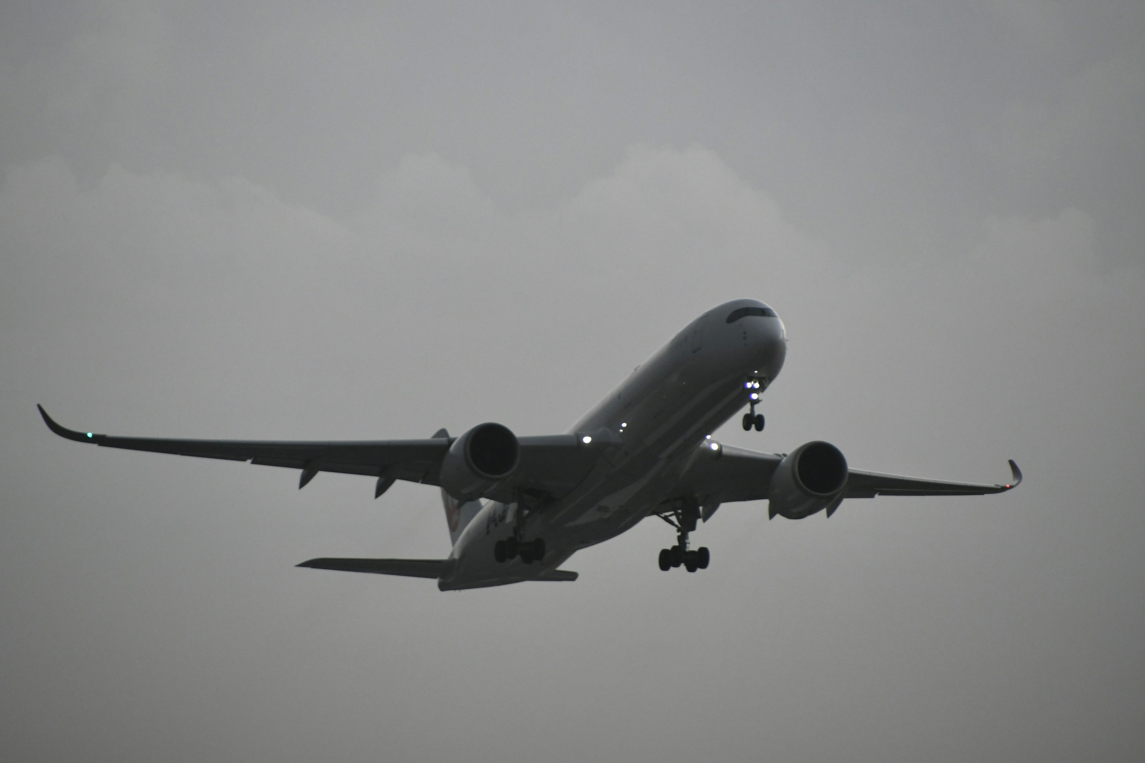 Airplane flying through cloudy skies