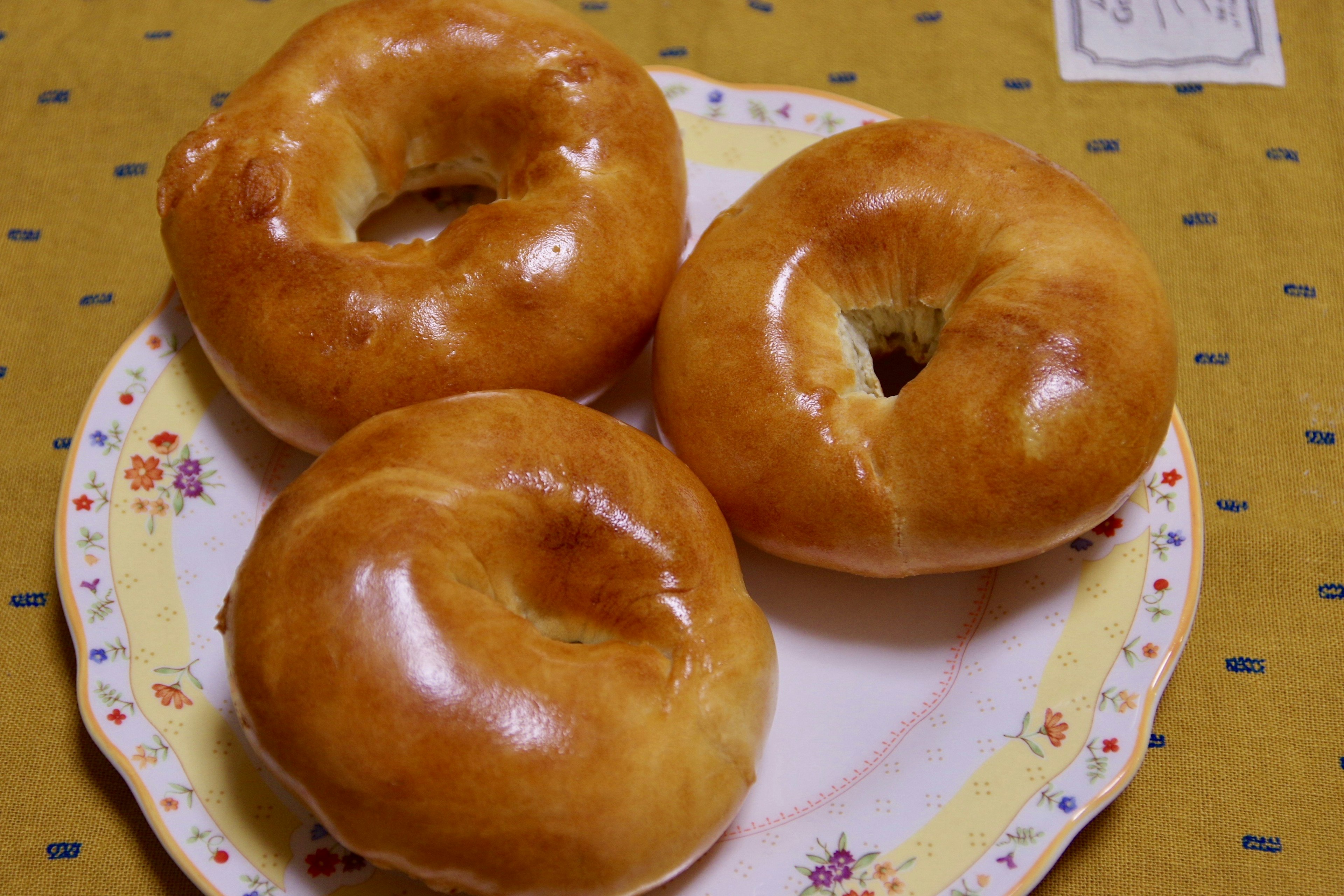 Three delicious bagels on a decorative plate