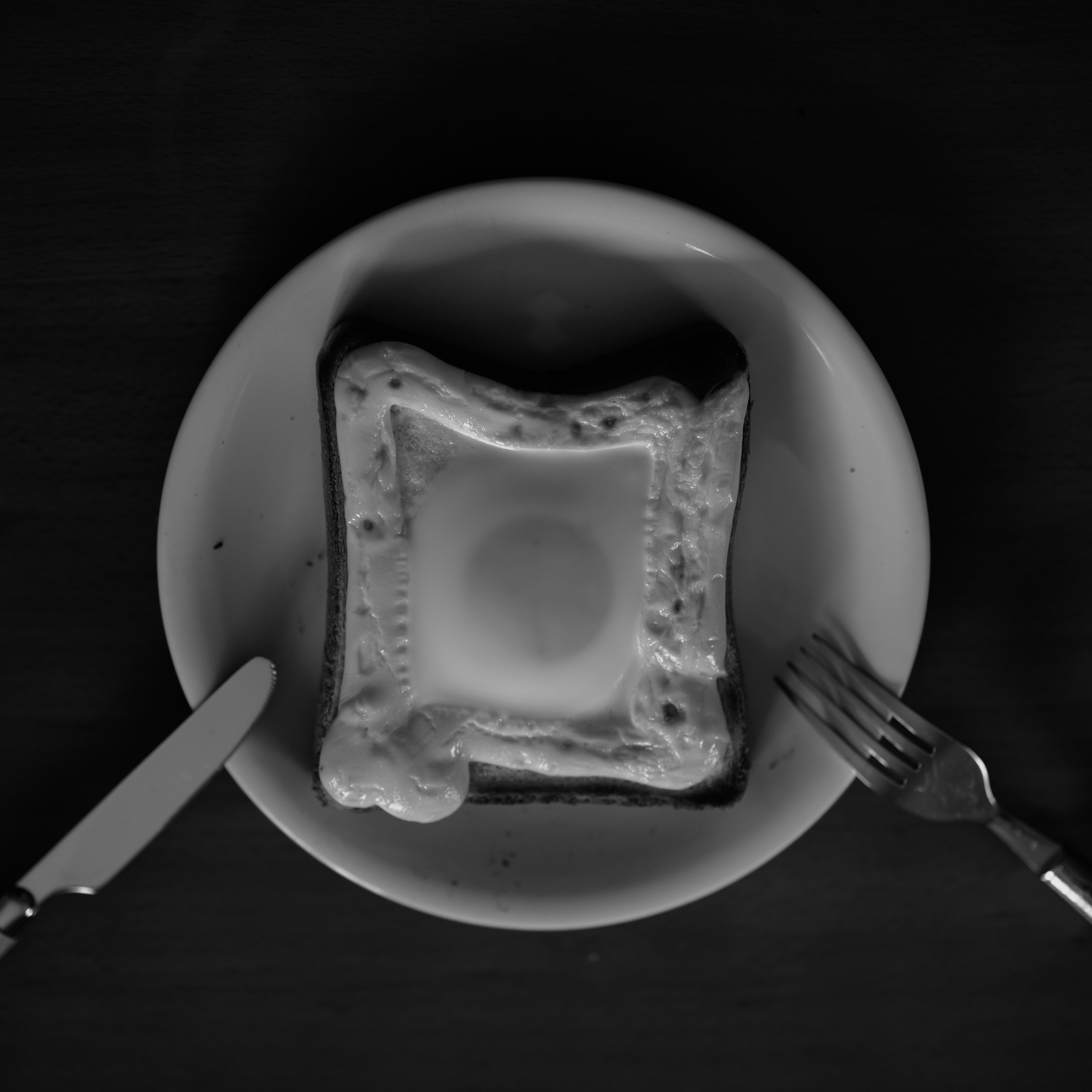 Top view of egg toast on a plate in black and white