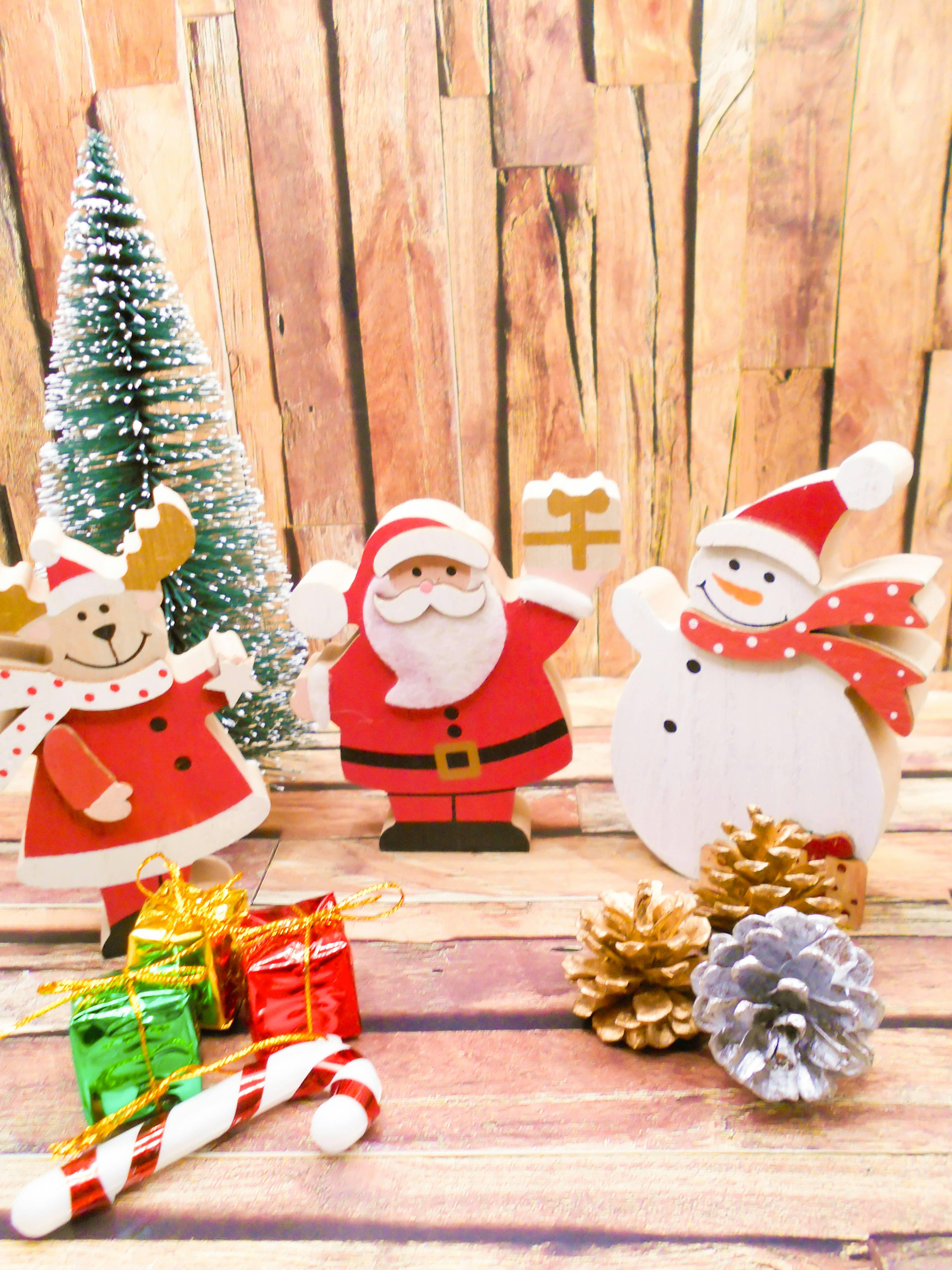 Christmas decorations featuring Santa Claus snowman reindeer wooden figures and small presents