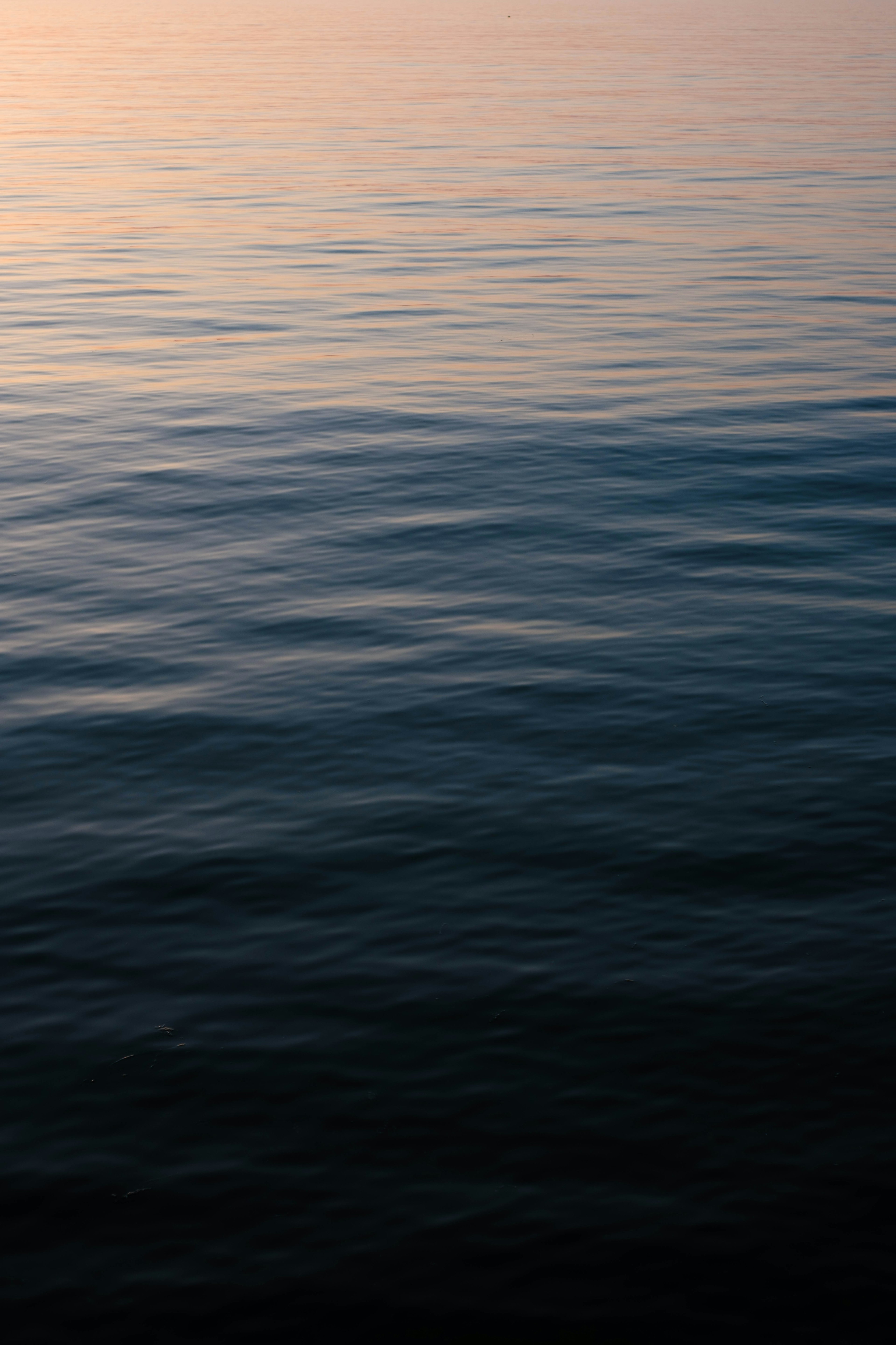 Calm water surface with gentle ripples and soft hues