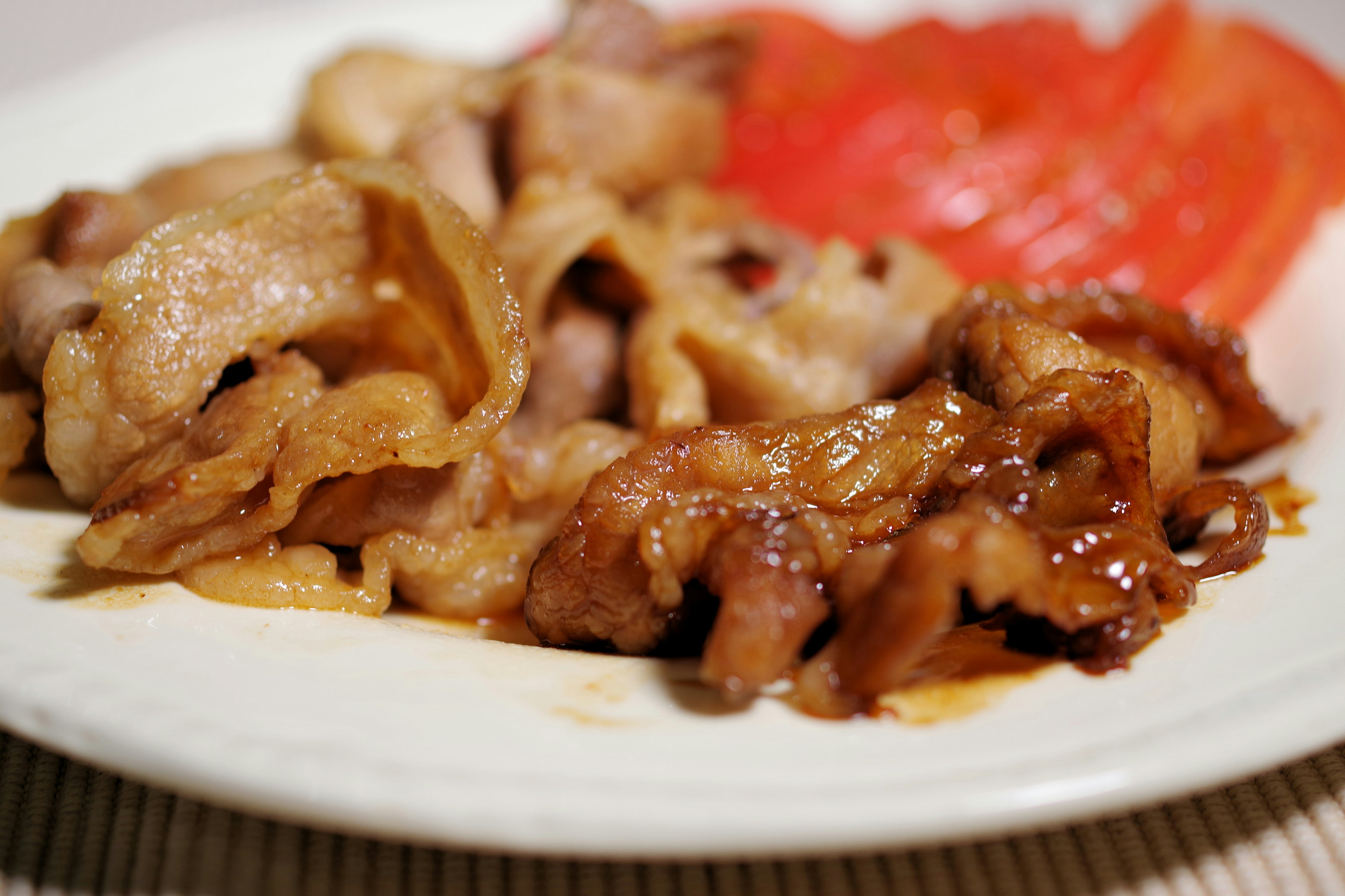 Sliced pork with tomato garnish