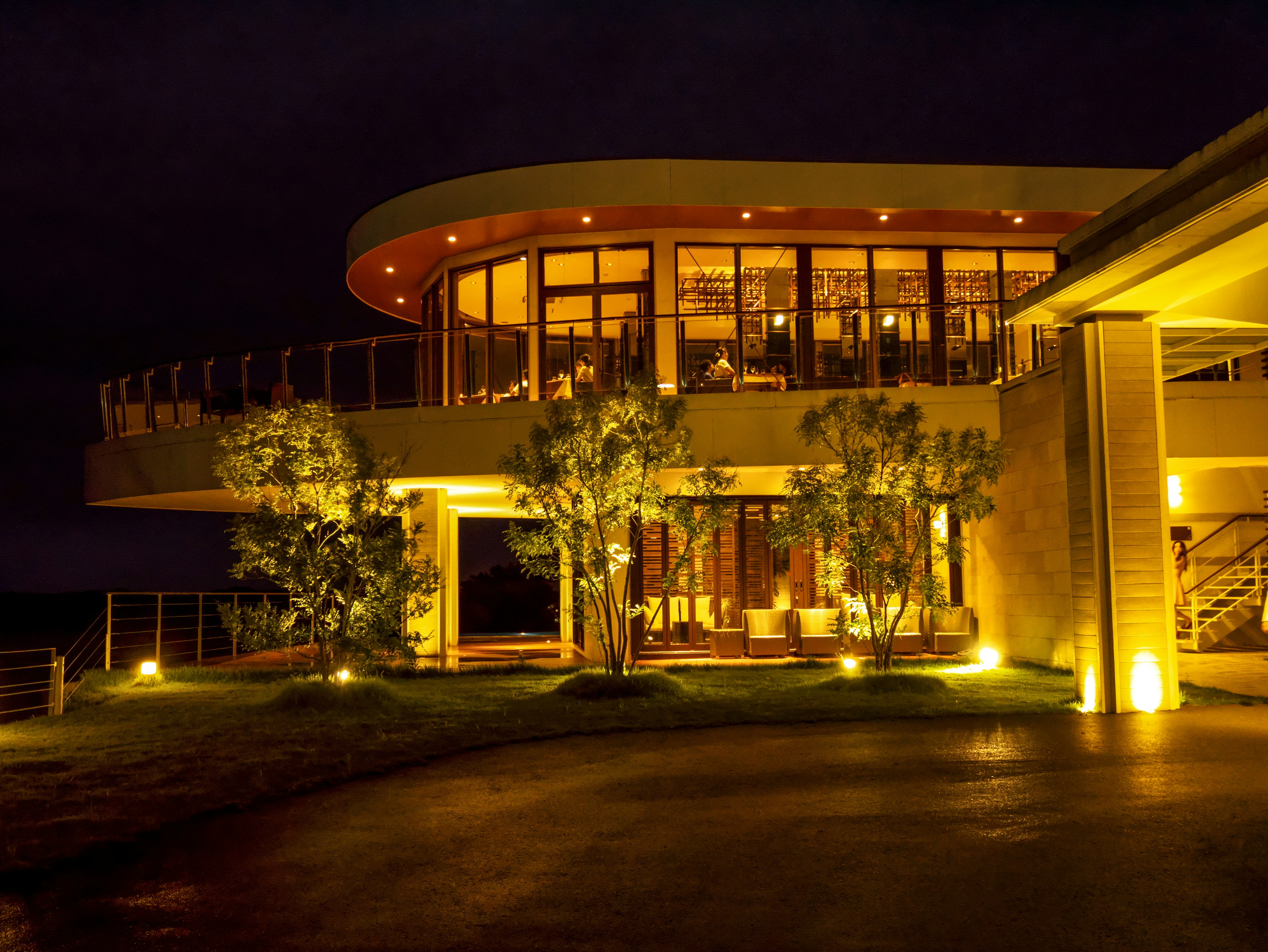 Hermosa fachada de un edificio de noche con diseño y paisaje iluminados