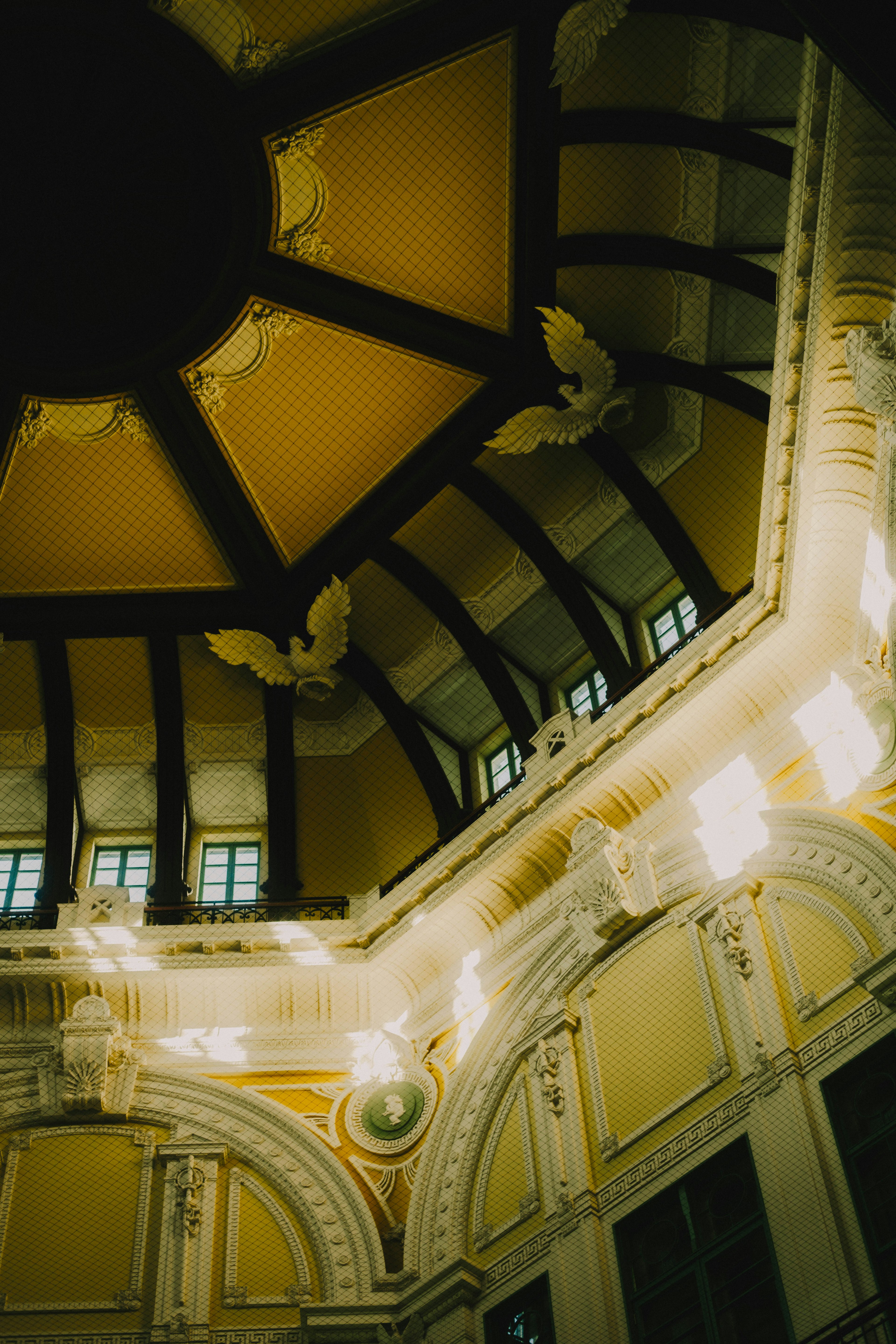 Elegant ceiling design with yellow walls and wooden beams decorative sculptures