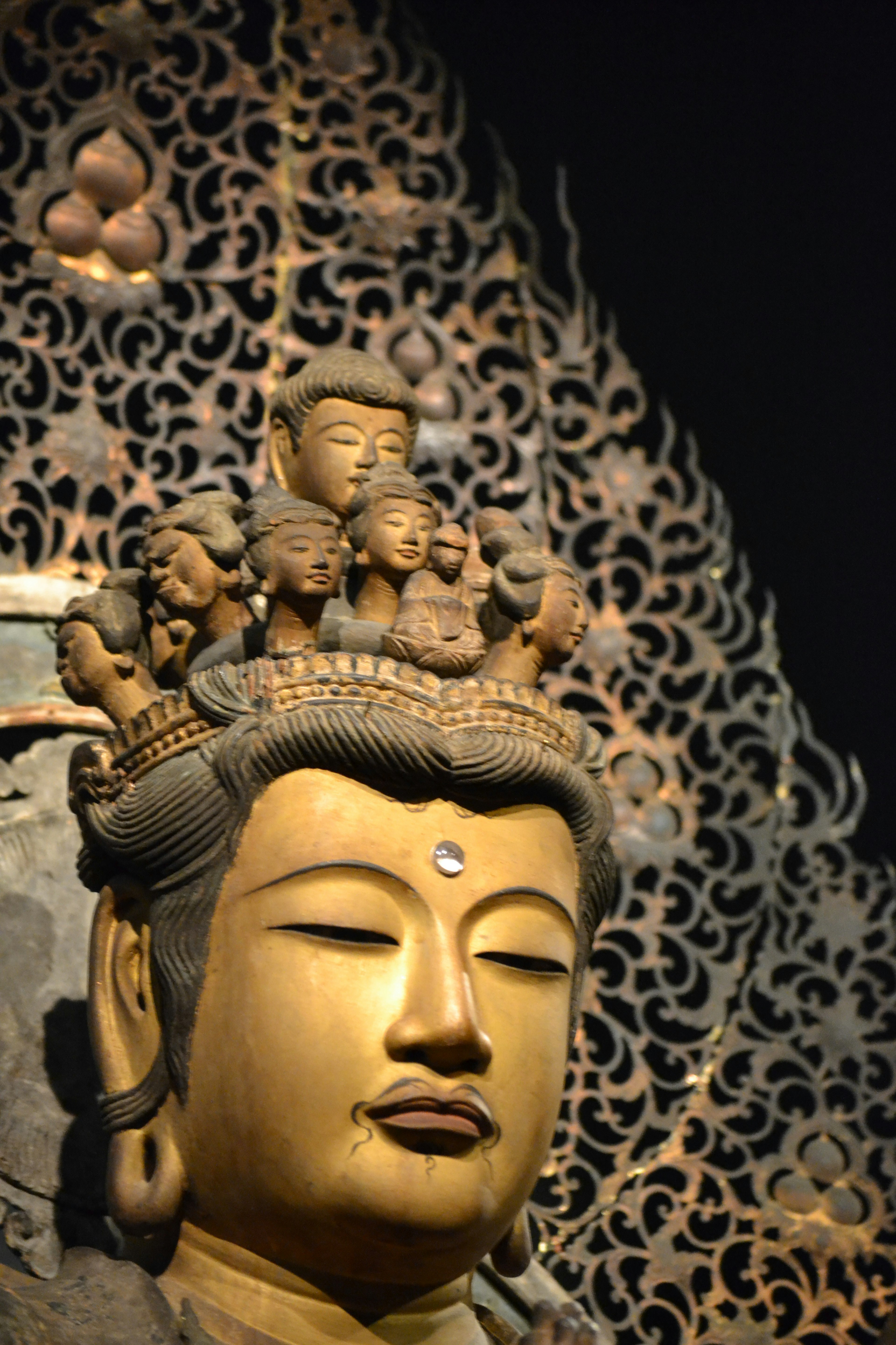 Golden Buddha statue with intricate headpiece and serene expression