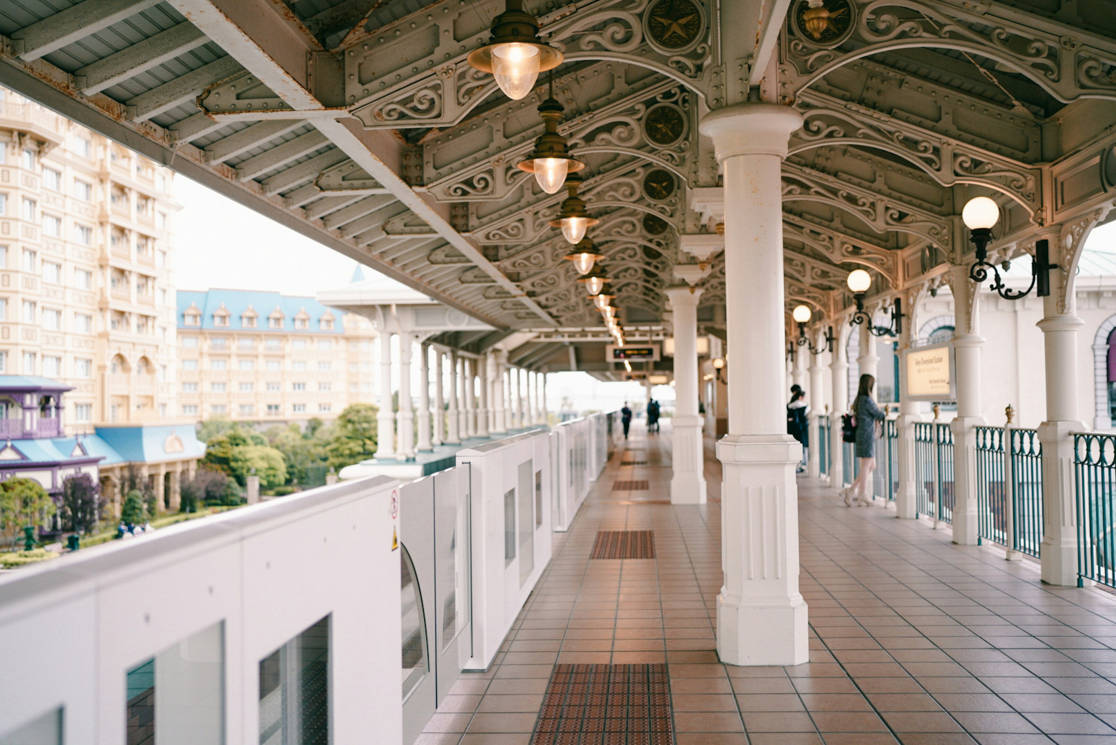 View of a beautiful arcade featuring decorative ceiling and people walking