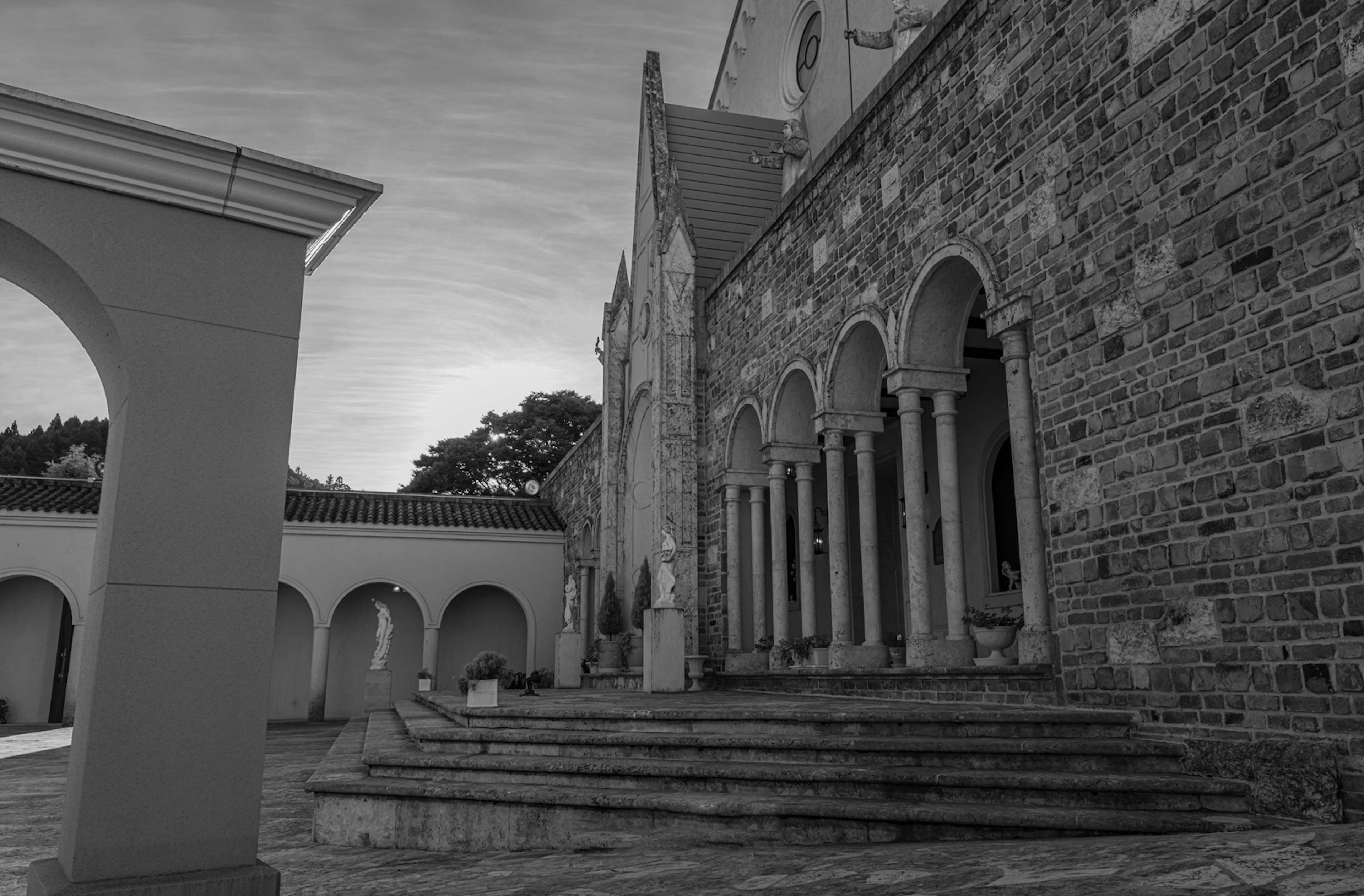 Stone building with columned stairs and arches