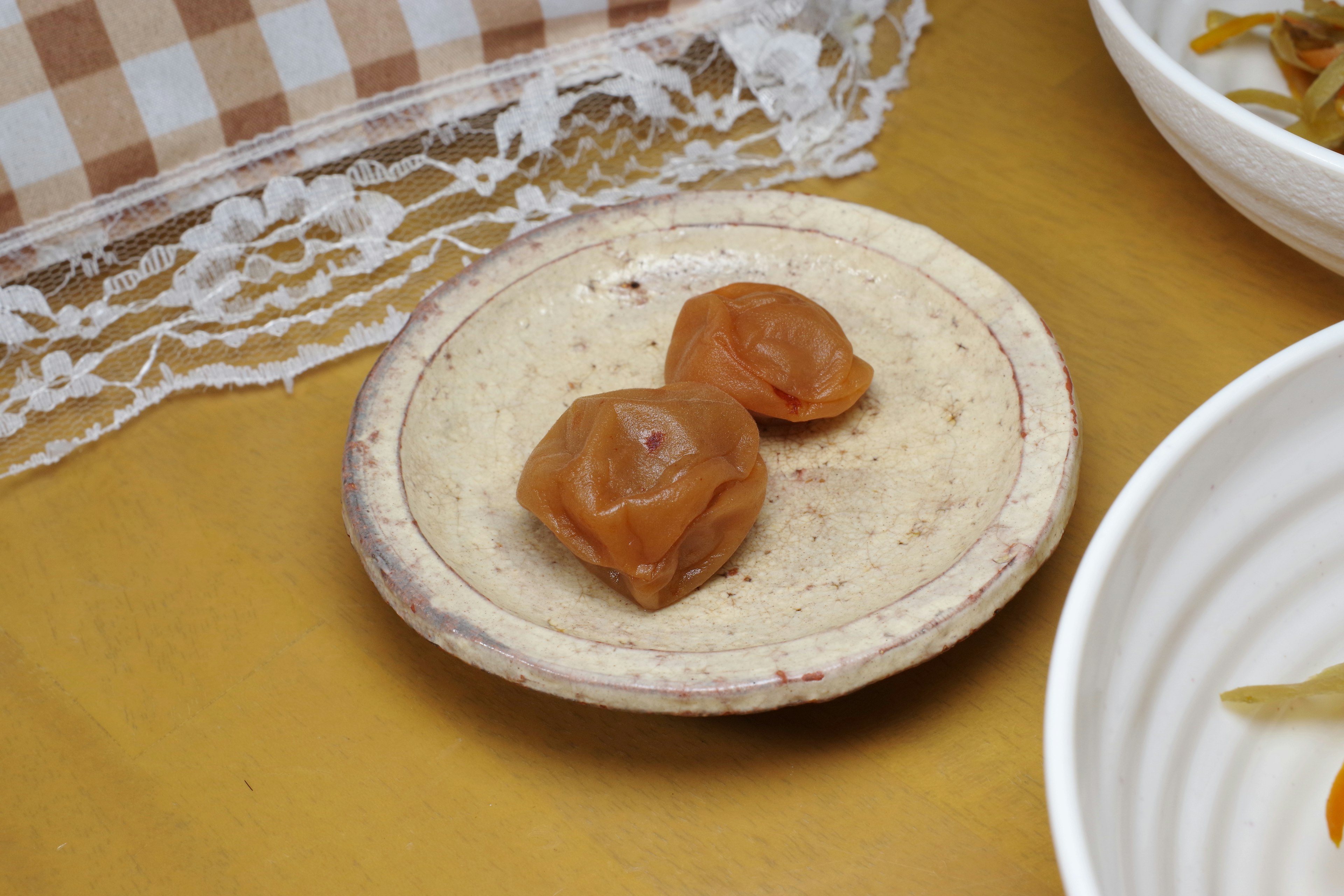 Two brown candies on a small plate