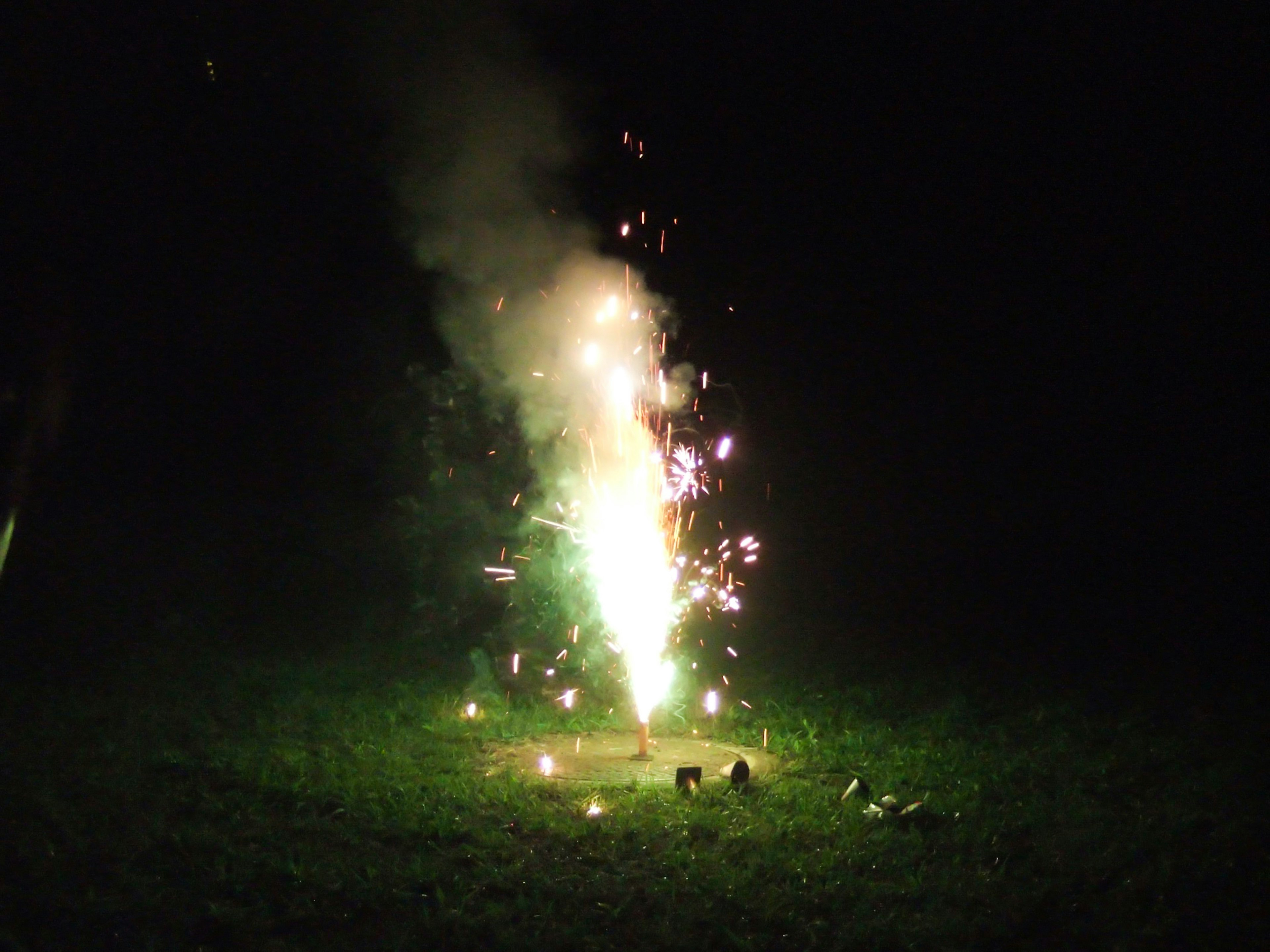 Firework fountain emitting sparks in the dark