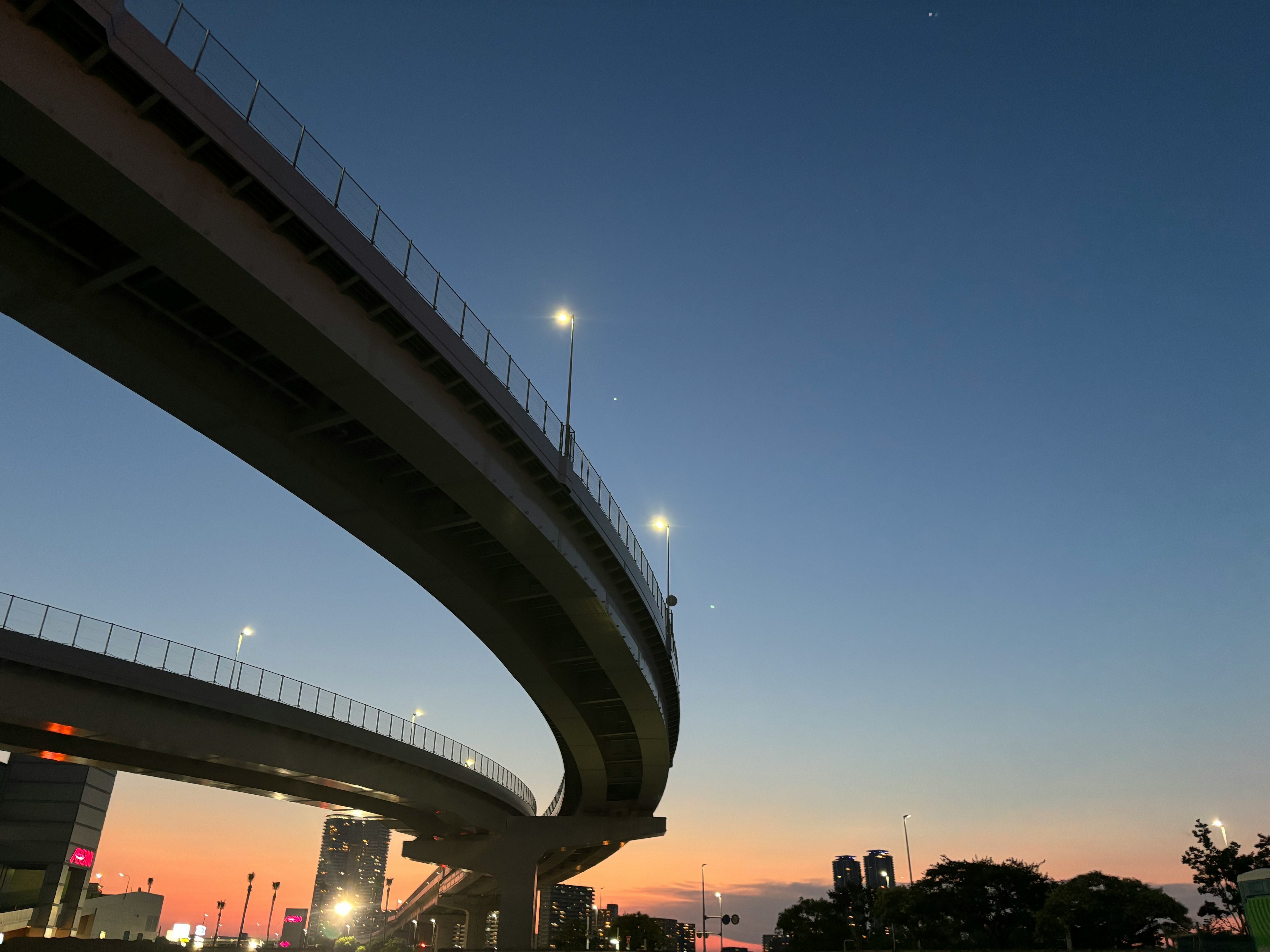 Silhouette of elevated highway under a sunset sky