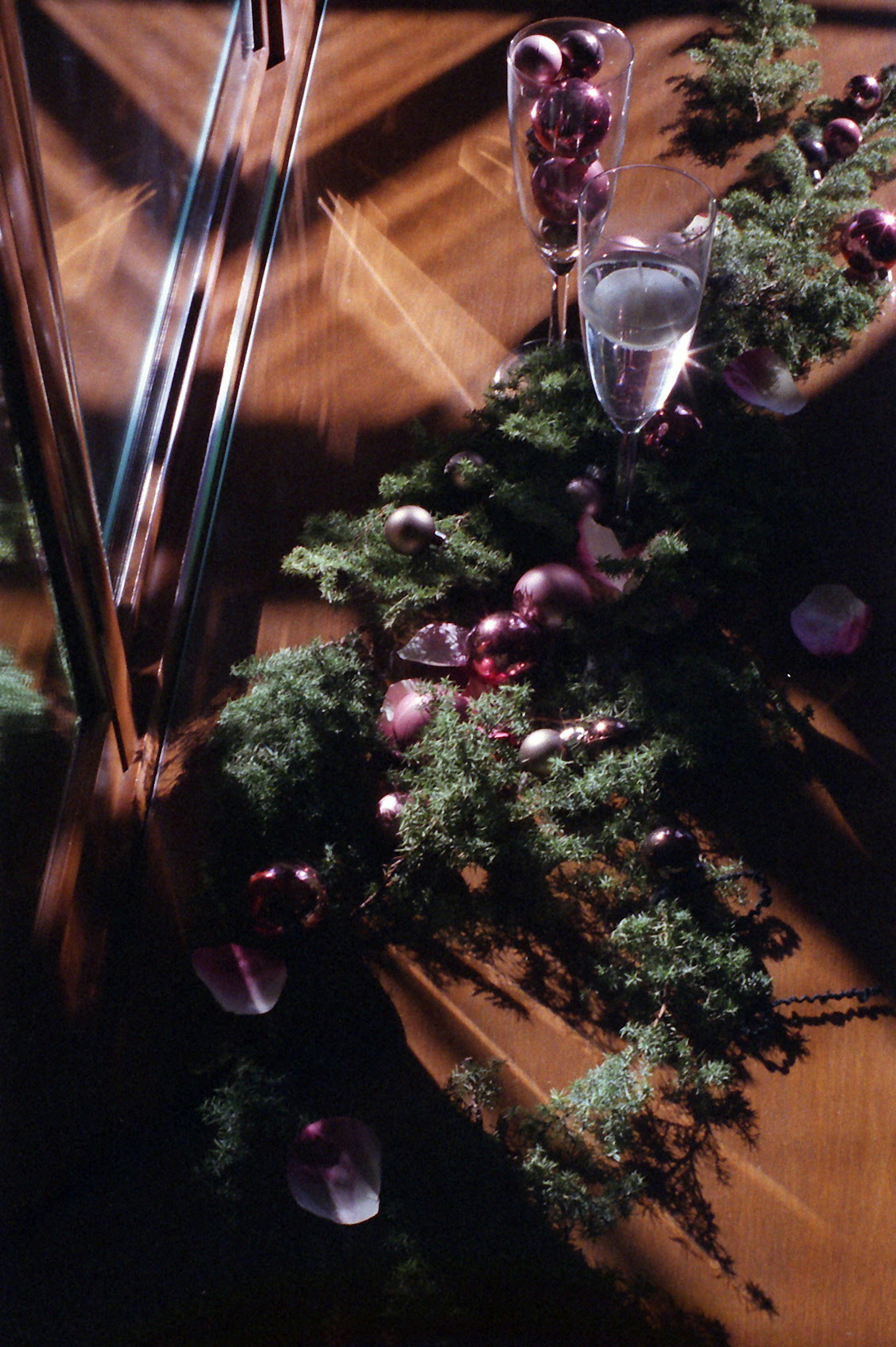 Christmas decorations on a wooden table with glasses and ornaments