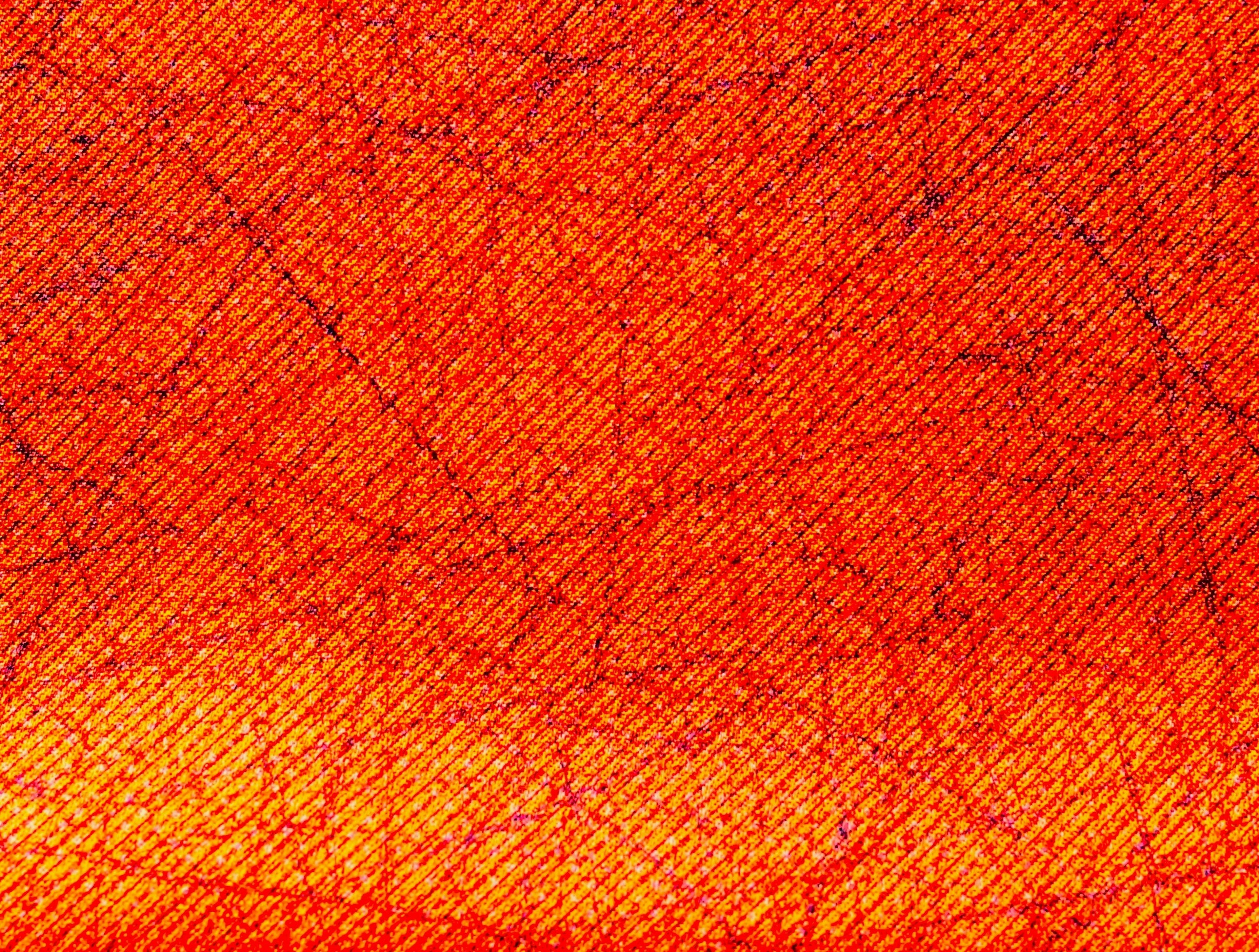 Close-up of fabric with orange gradient and fine texture