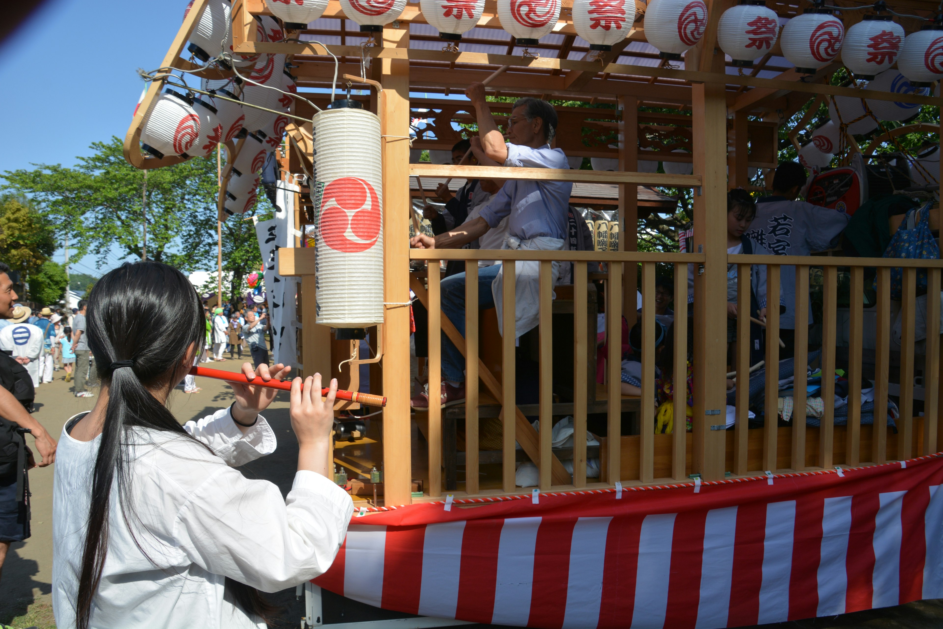 Festival float with participants playing music and traditional attire