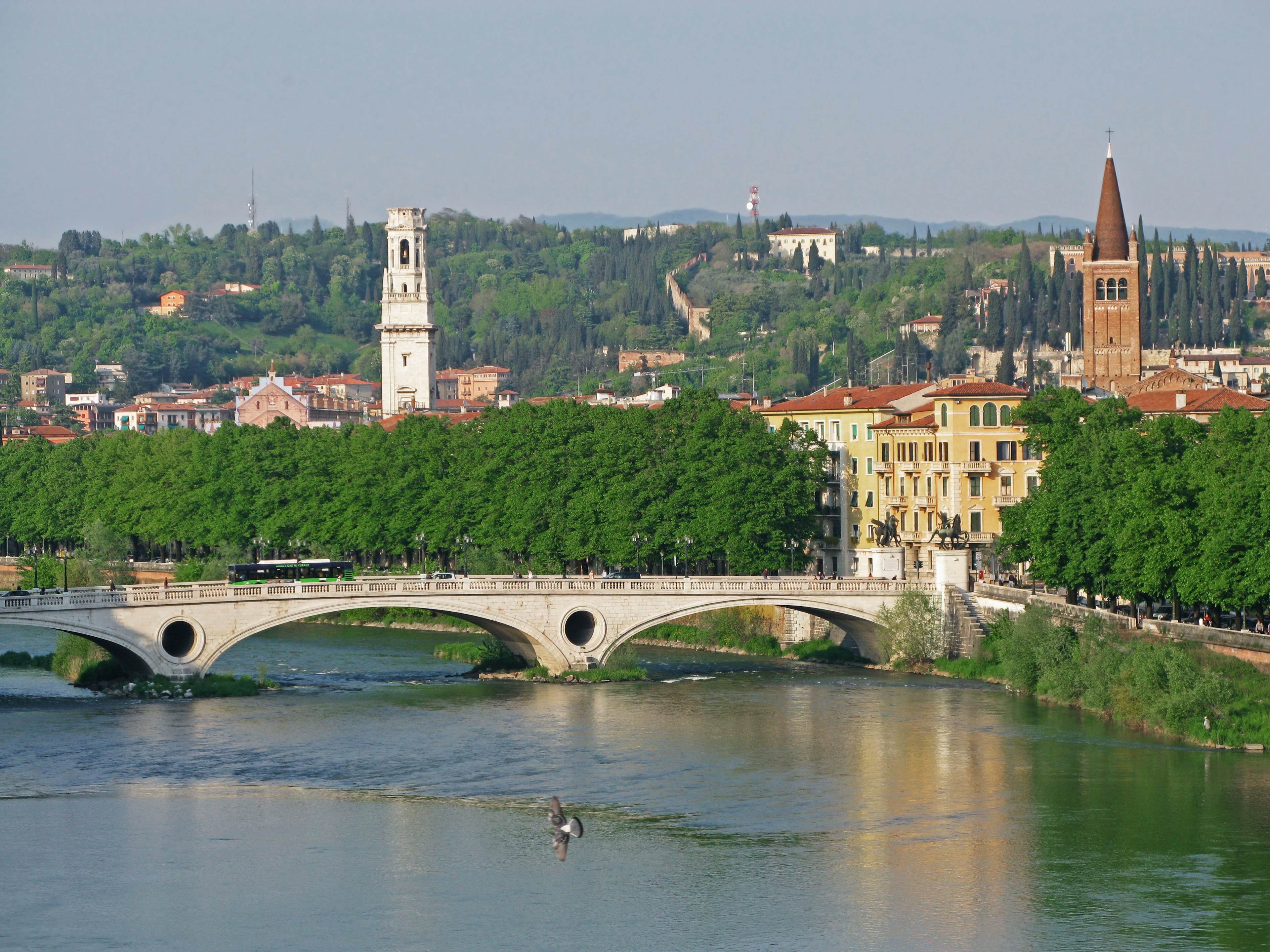 Scenic view of an Italian city with a river and bridge