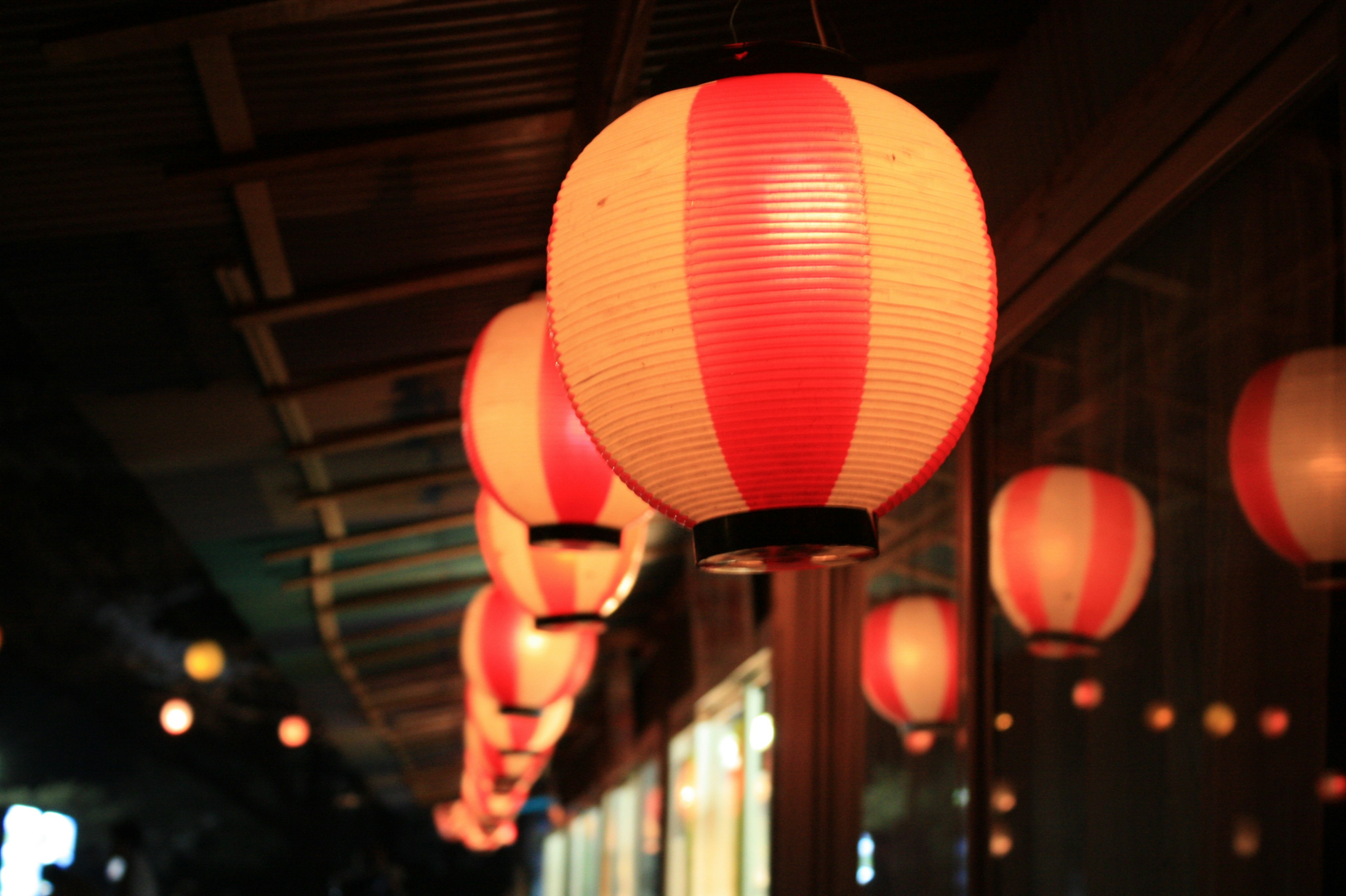 Row of red and white lanterns illuminating a night scene