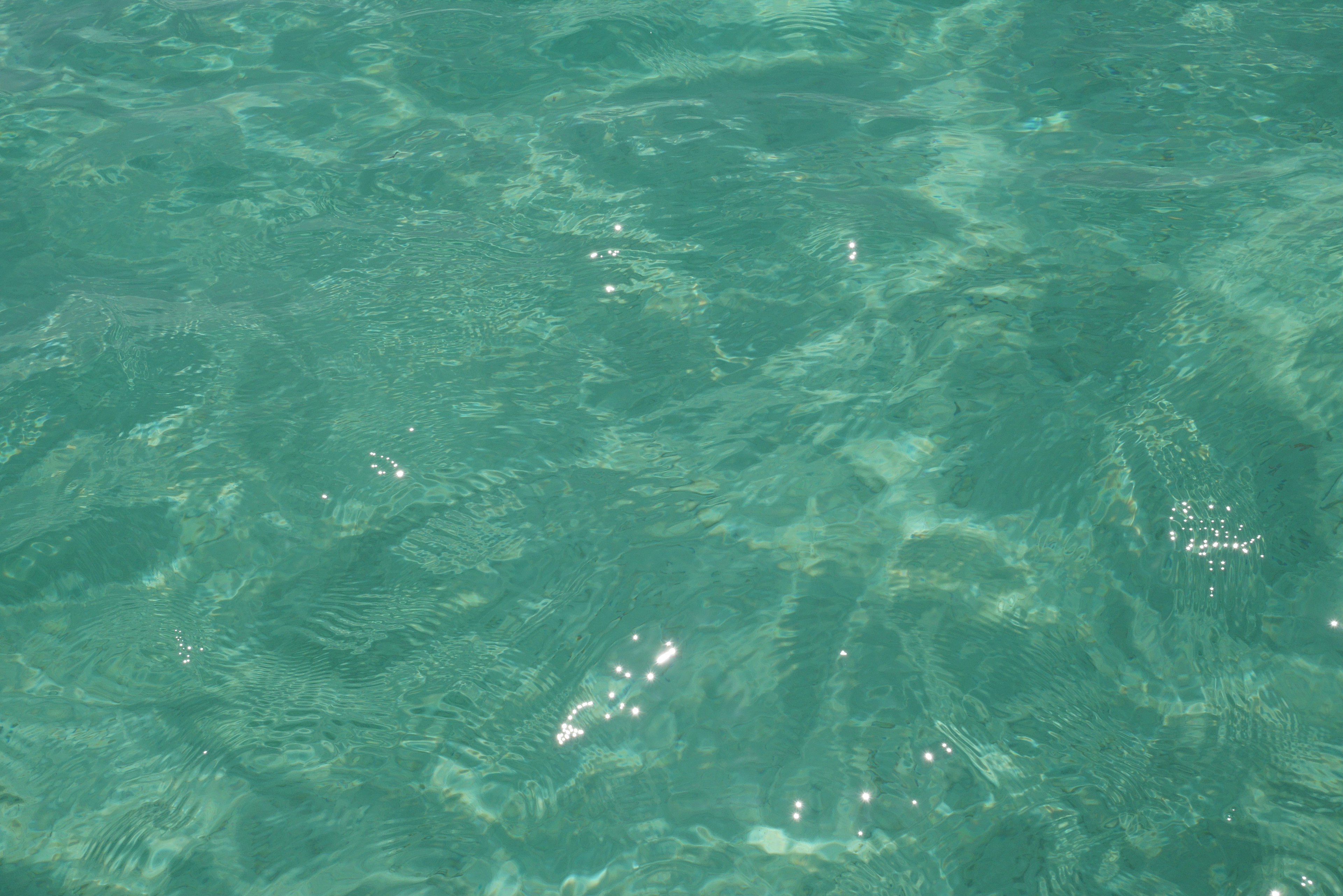 Clear turquoise water surface with light reflections