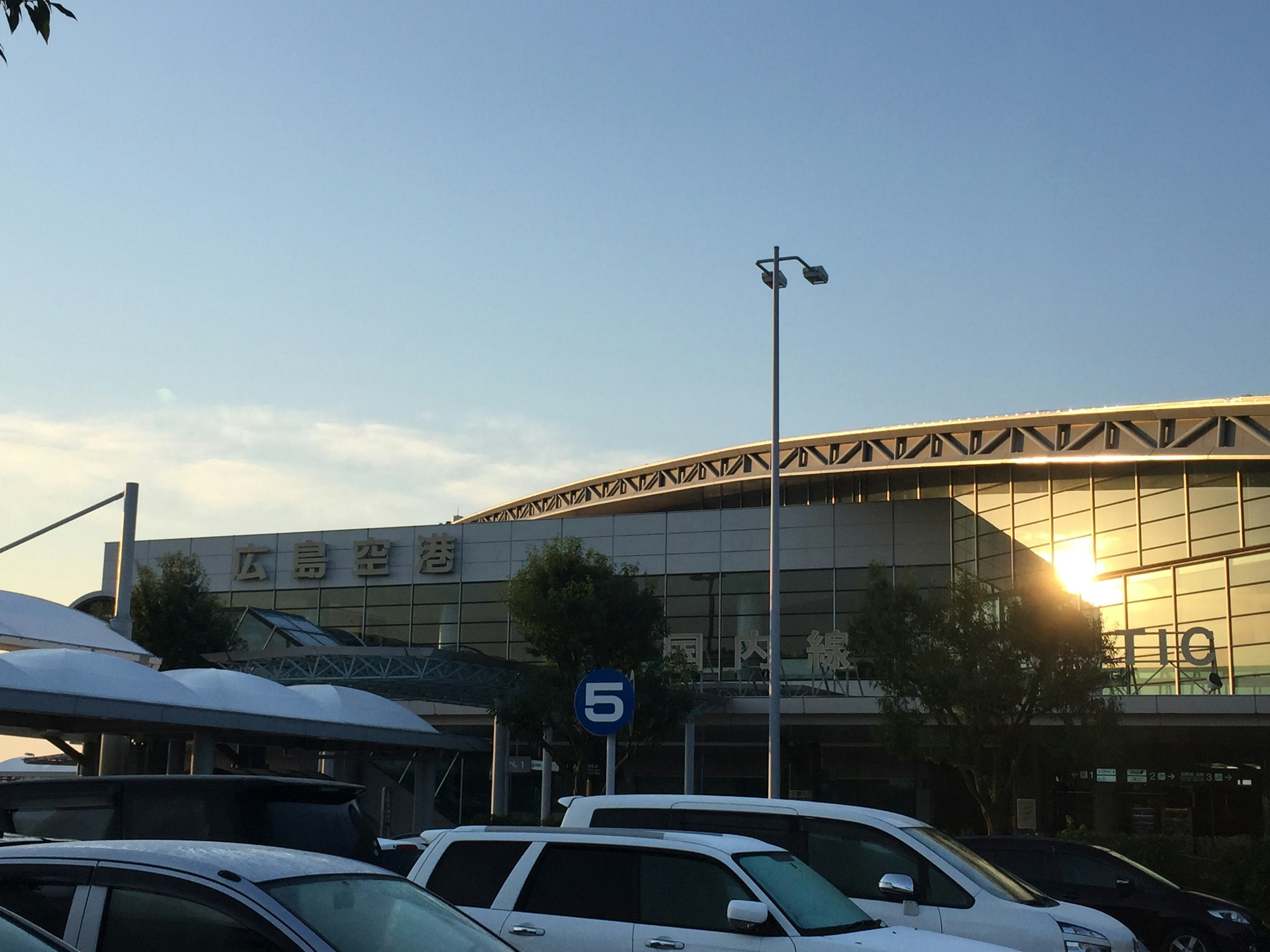 Modern building exterior with a parking lot and blue sky