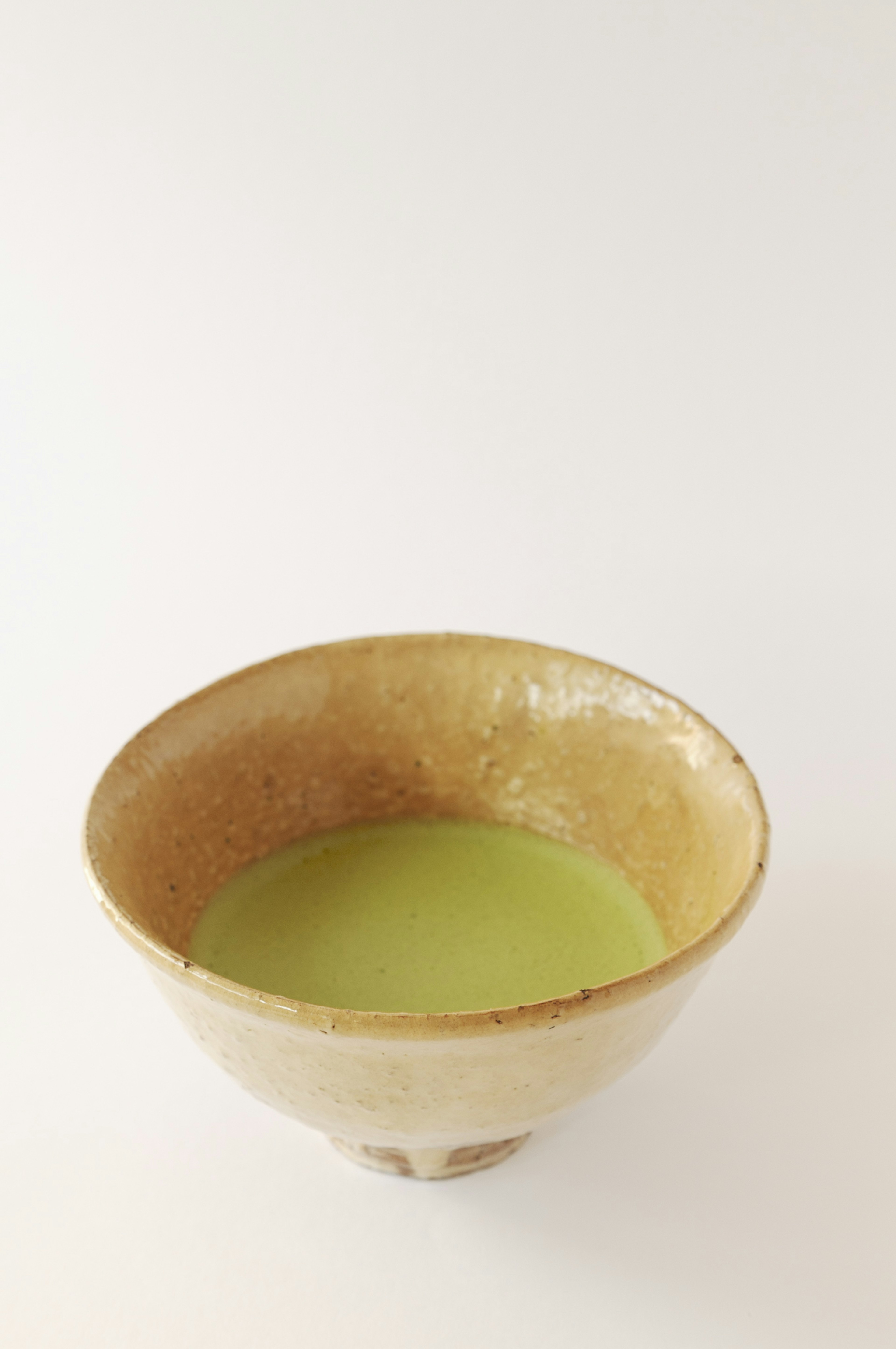 Ceramic bowl filled with green matcha tea