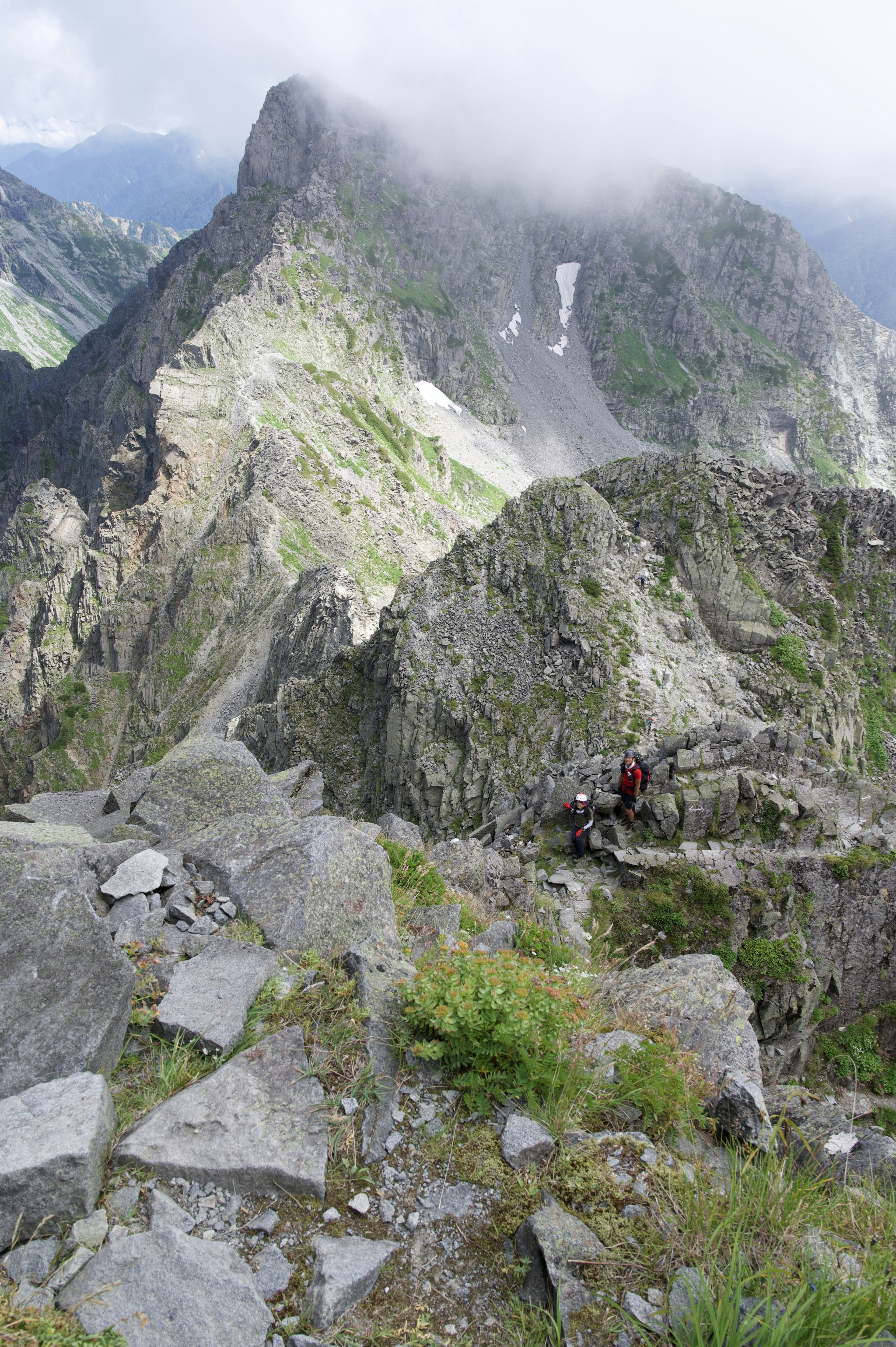 rugged mountain landscape with hikers visible