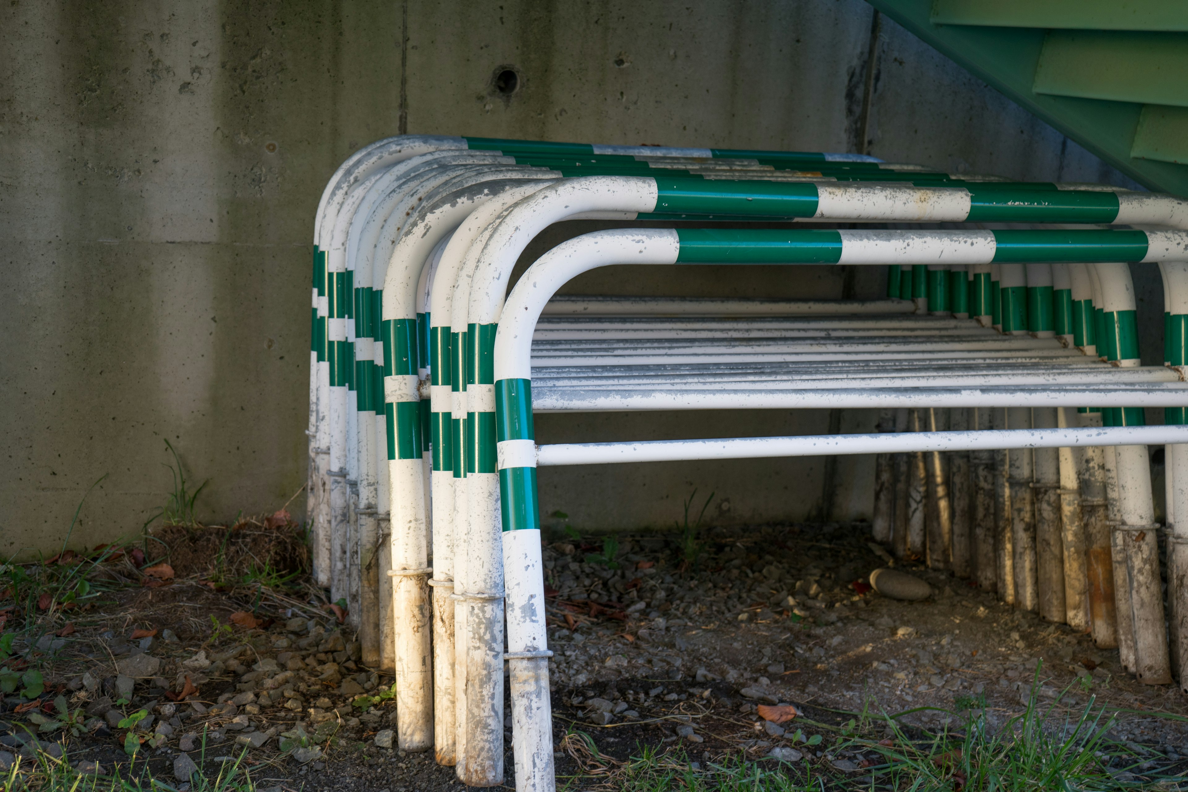 Stacked white and green striped pipes