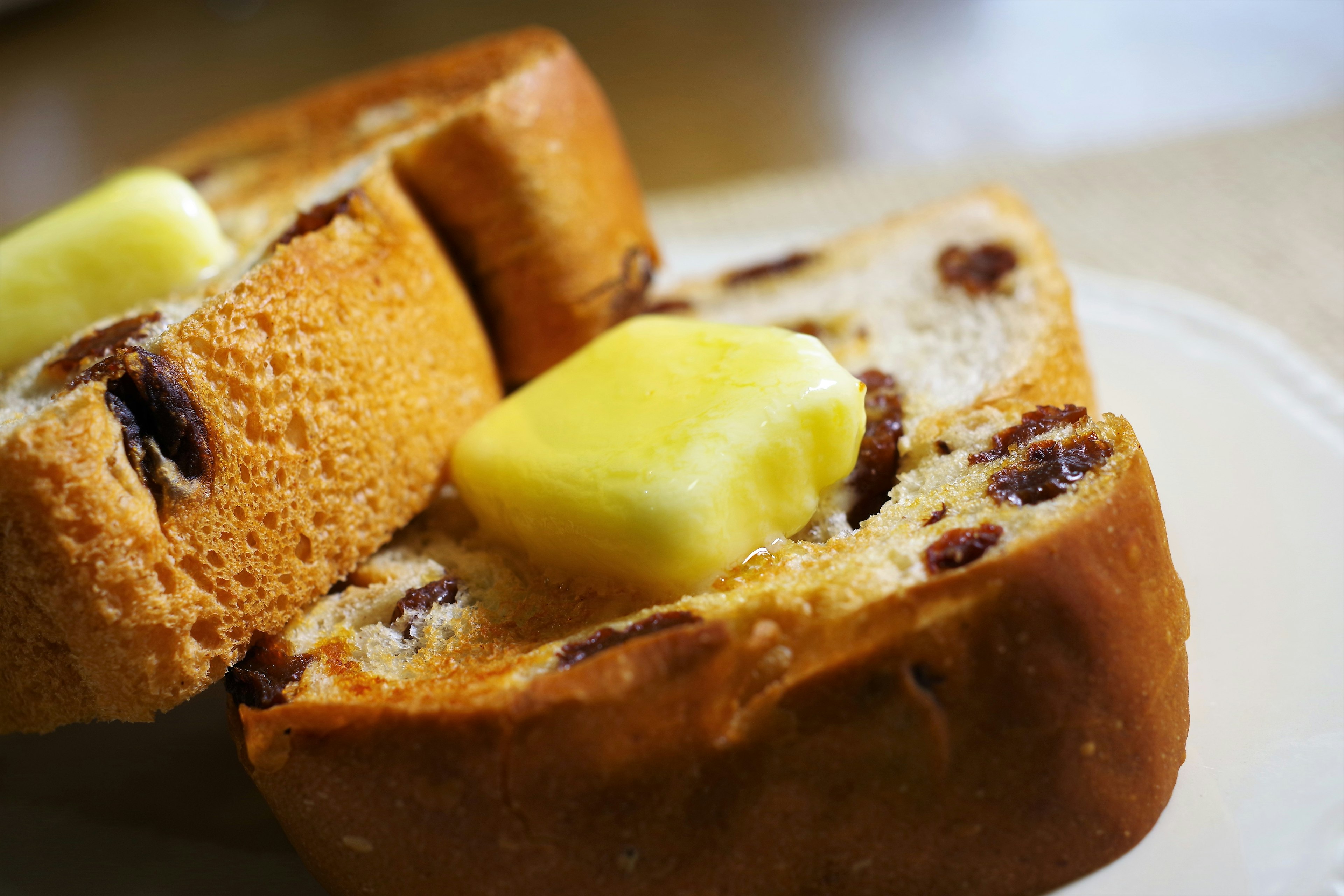 Slices of raisin bread with butter on top