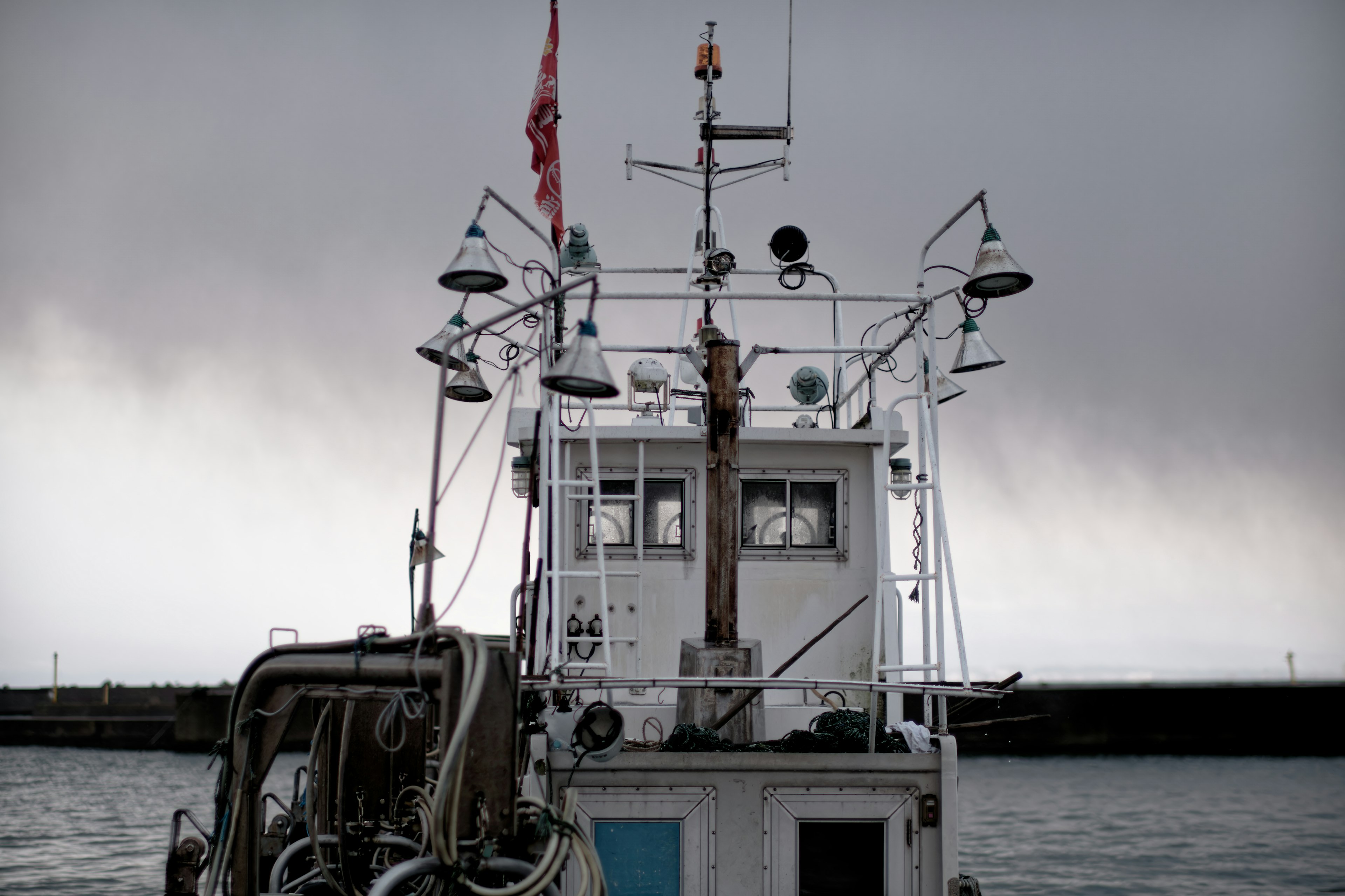 Rear view of a fishing boat under a dark sky