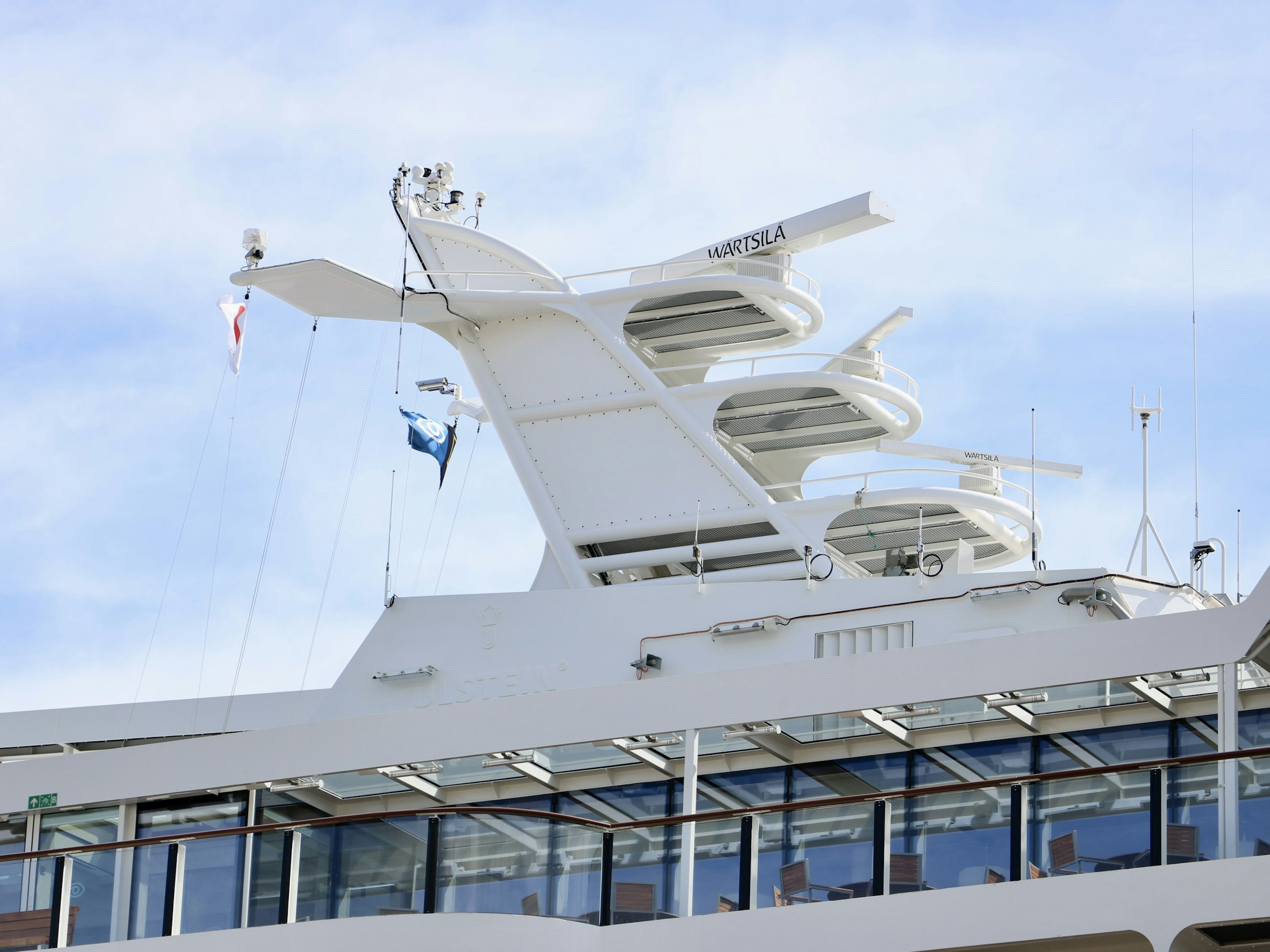 Detail of a white cruise ship's upper structure and deck