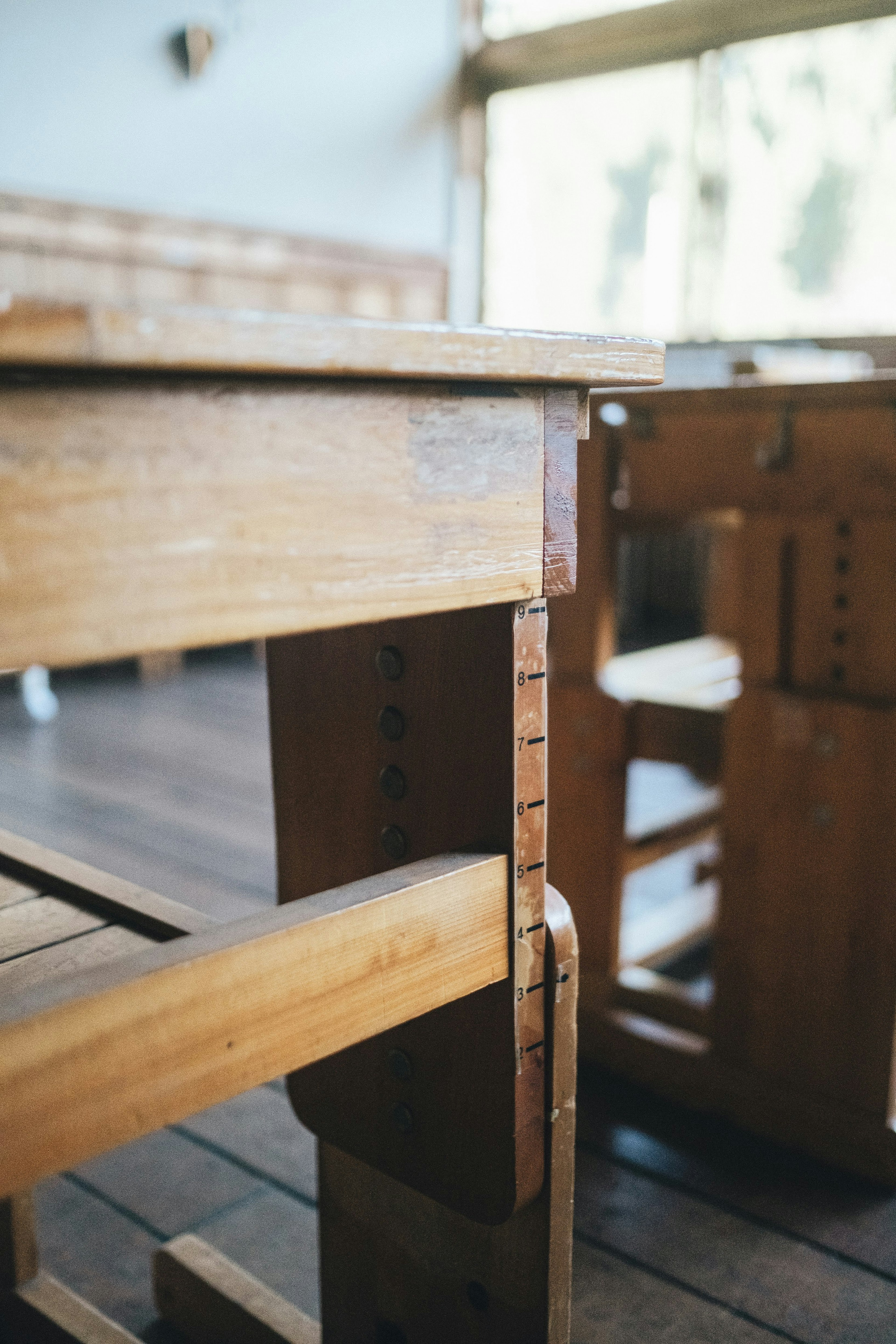 Interior featuring wooden desks with warm light streaming in