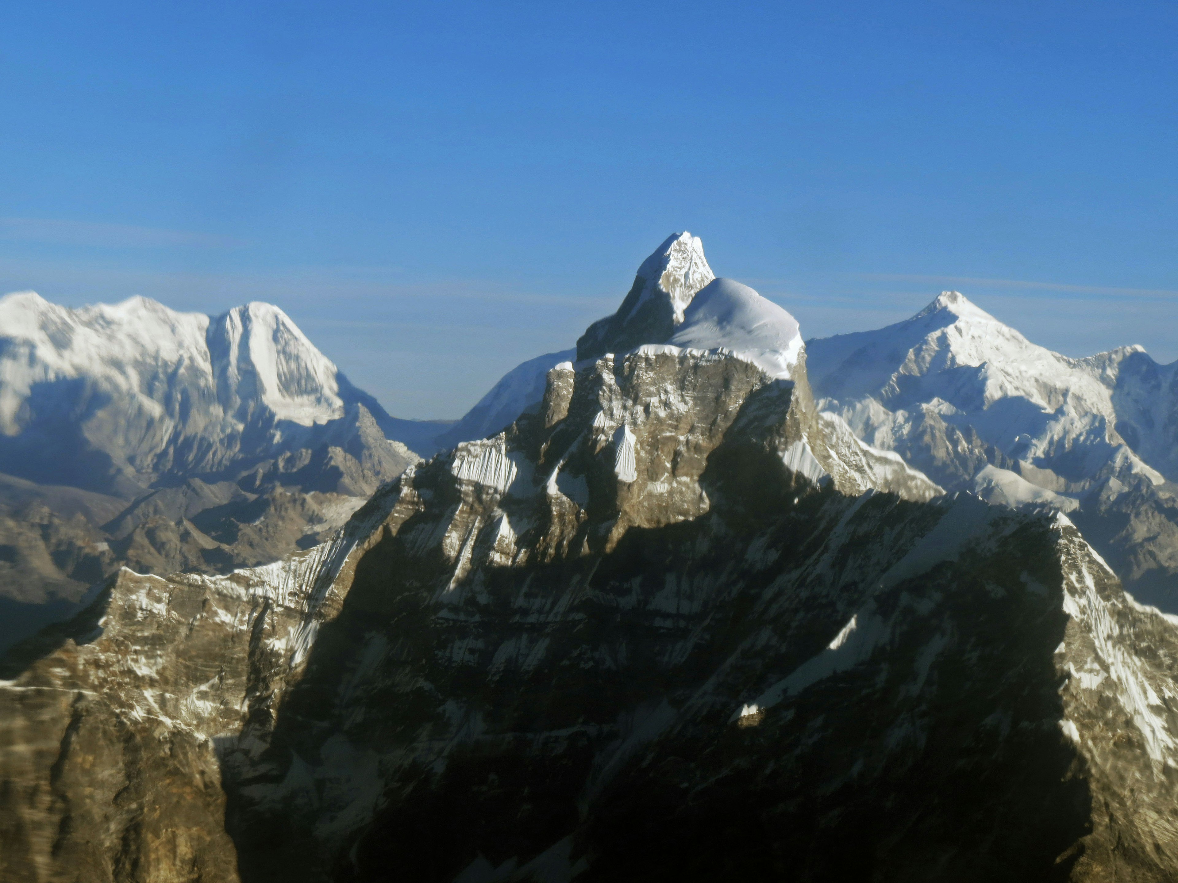 Snow-capped mountains under a clear blue sky