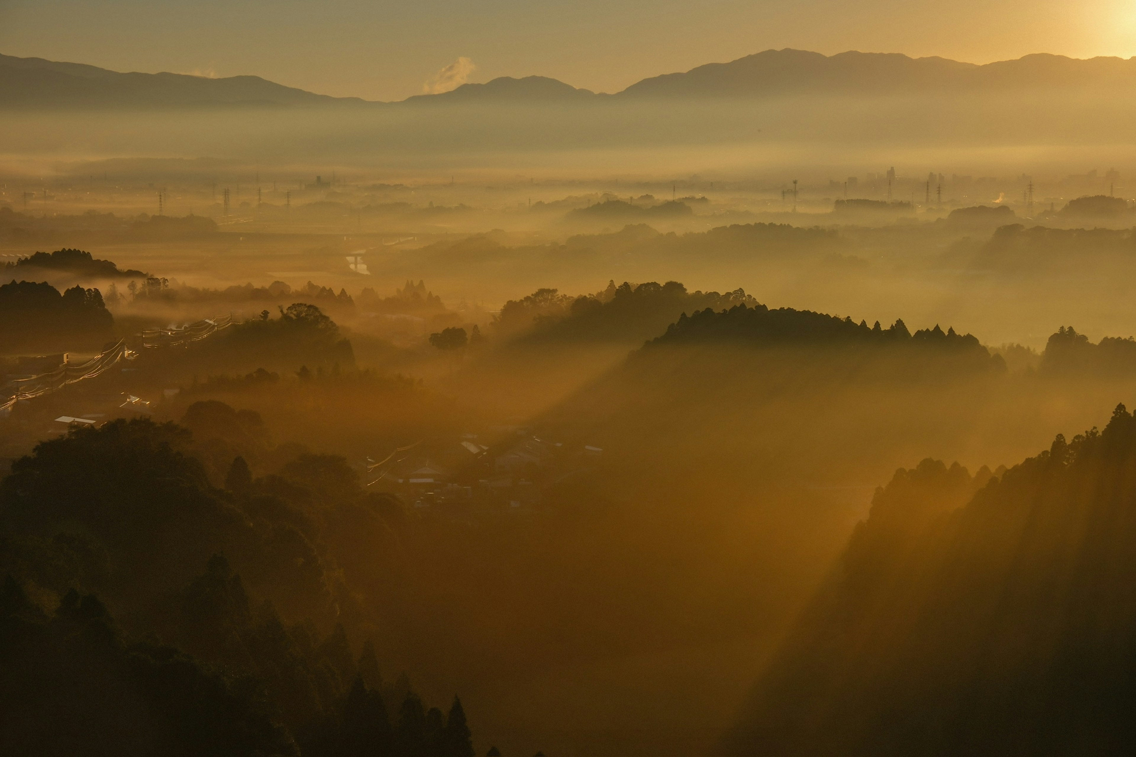 Misty mountains with golden light streaming through